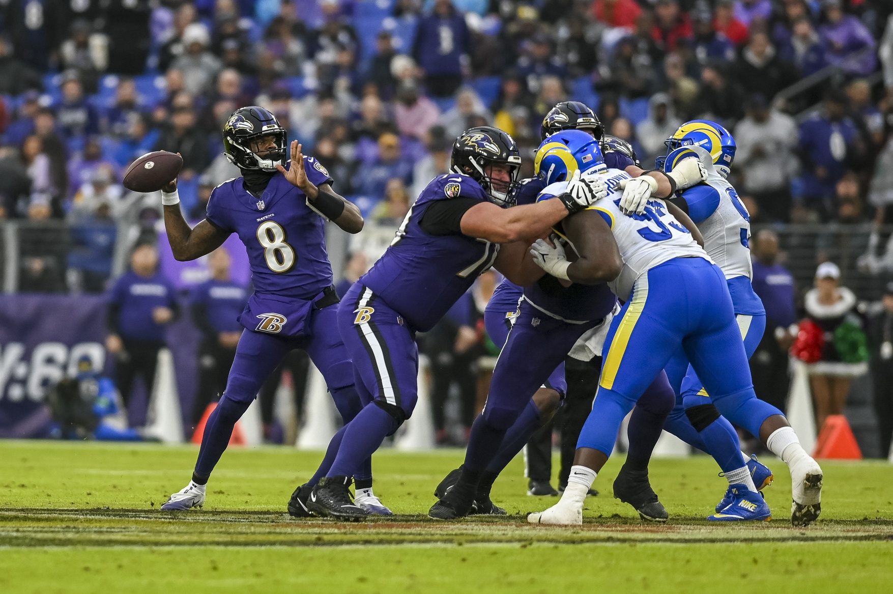 Baltimore Ravens quarterback Lamar Jackson (8) throws for a touchdown during the second quarter against the Los Angeles Rams at M&T Bank Stadium.