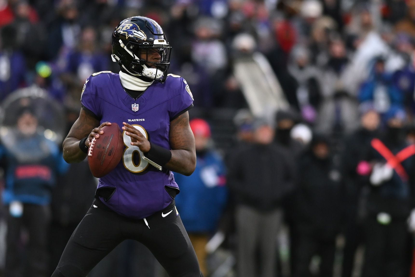 Baltimore Ravens quarterback Lamar Jackson (8) drops back to throw against the Houston Texans in the first quarter of a 2024 AFC divisional round game at M&T Bank Stadium.