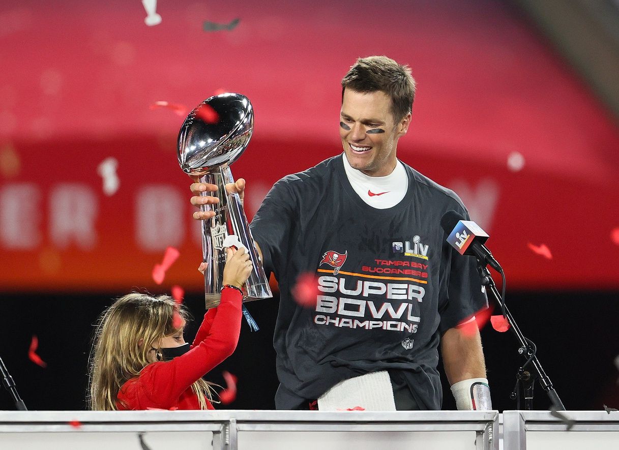 Tampa Bay Buccaneers quarterback Tom Brady (12) hoists the Vince Lombardi Trophy with his daughter, Vivian, after defeating the Kansas City Chiefs in Super Bowl LV at Raymond James Stadium.