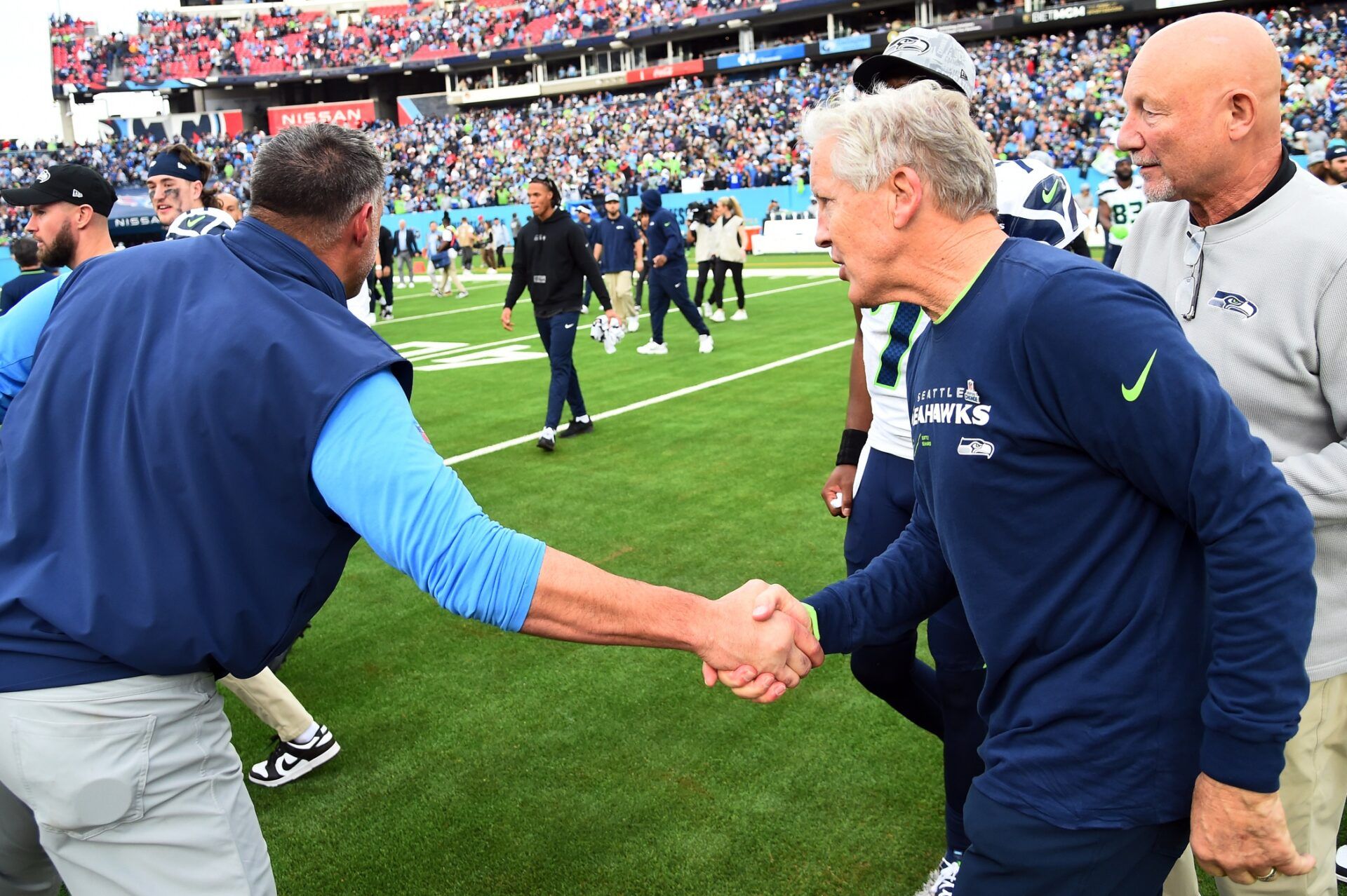 Seattle Seahawks head coach Pete Carroll shakes hands with Tennessee Titans head coach Mike Vrabel.