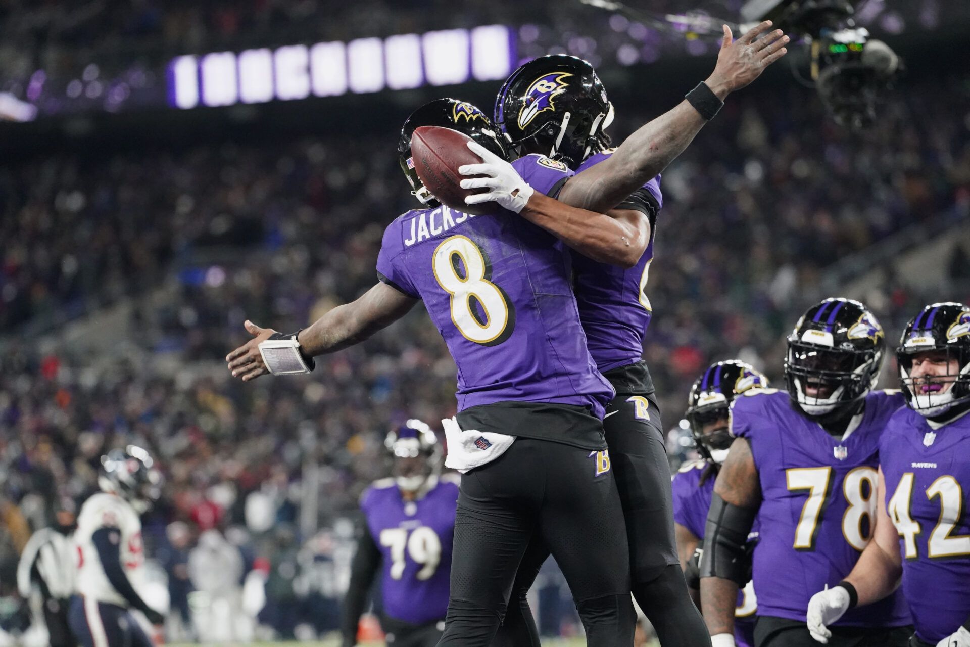 Baltimore Ravens tight end Isaiah Likely (80) celebrates with quarterback Lamar Jackson (8) after catching a pass for a touchdown against the Houston Texans during the fourth quarter of a 2024 AFC divisional round game at M&T Bank Stadium.