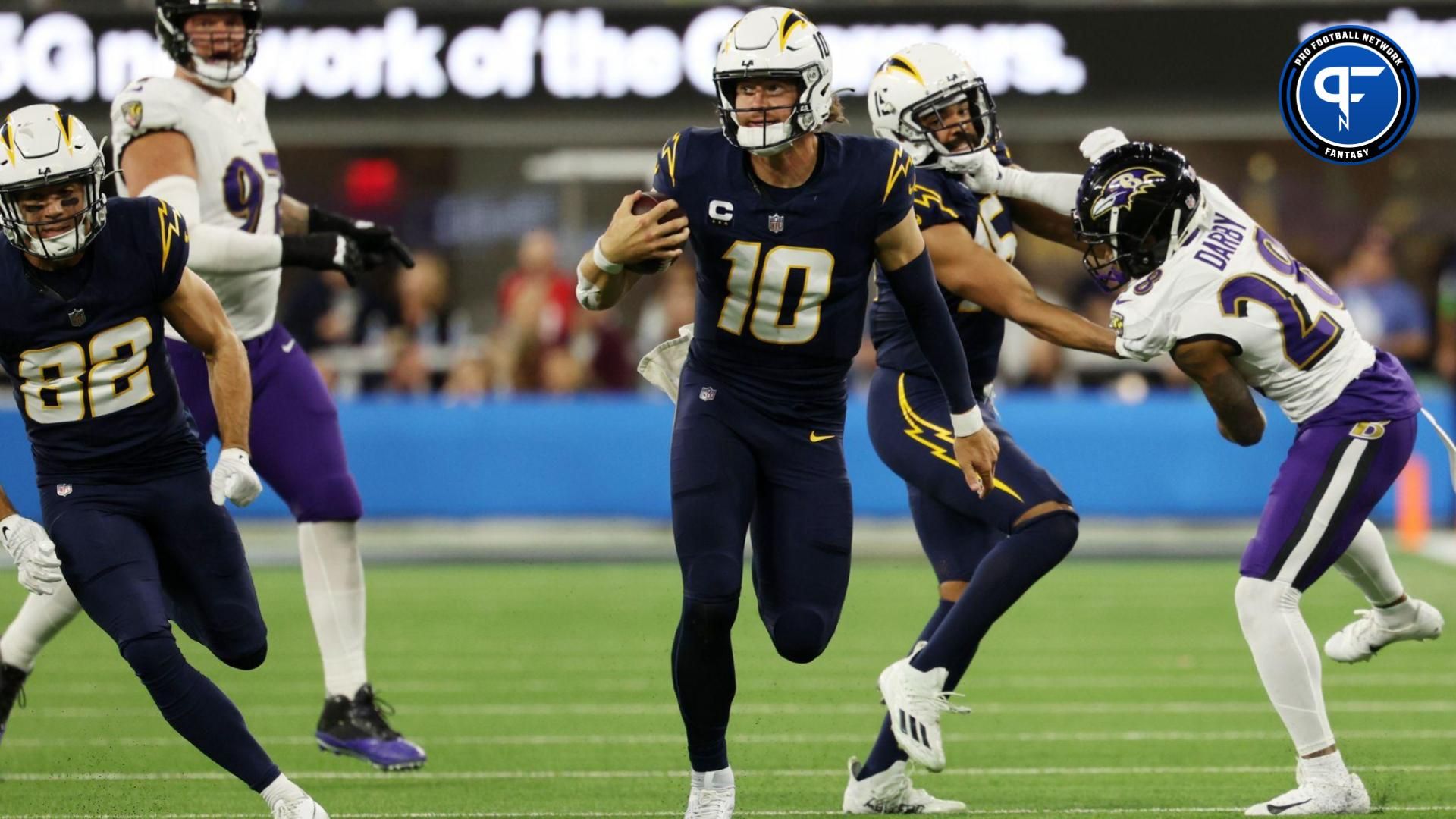 Los Angeles Chargers quarterback Justin Herbert (10) scrambles for a 35-yard run during the fourth quarter against the Baltimore Ravens at SoFi Stadium.