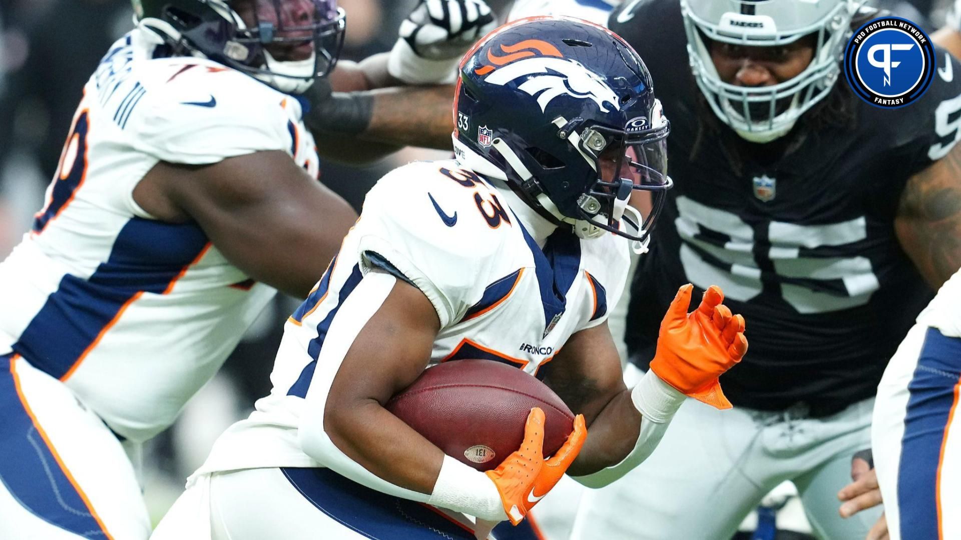 Denver Broncos running back Javonte Williams (33) carries against the Las Vegas Raiders during the first quarter at Allegiant Stadium.