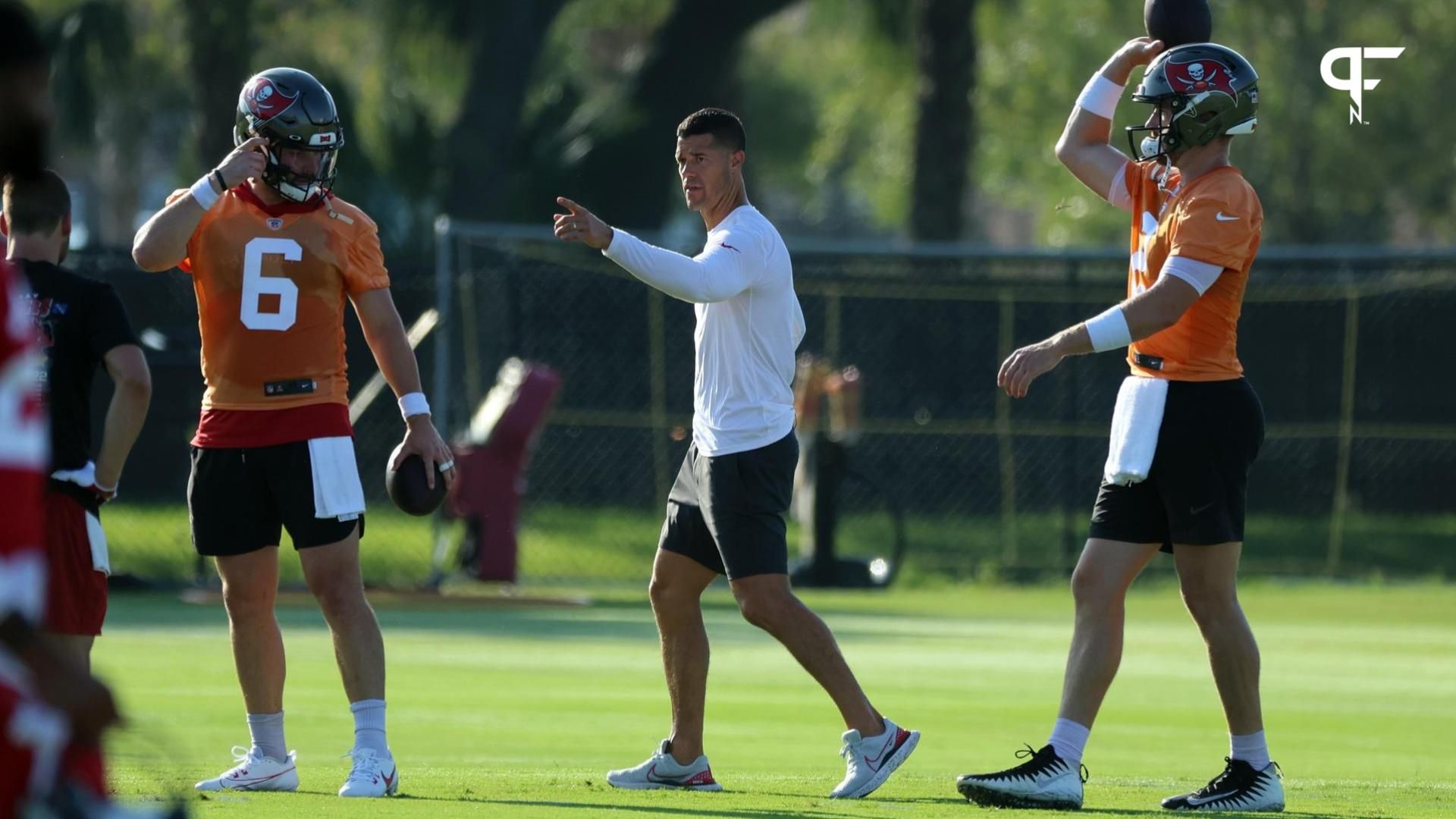 Tampa Bay Buccaneers offensive coordinator Dave Canales talks with quarterback Baker Mayfield (6) and quarterback Kyle Trask (2) during training camp at AdventHealth Training Center.