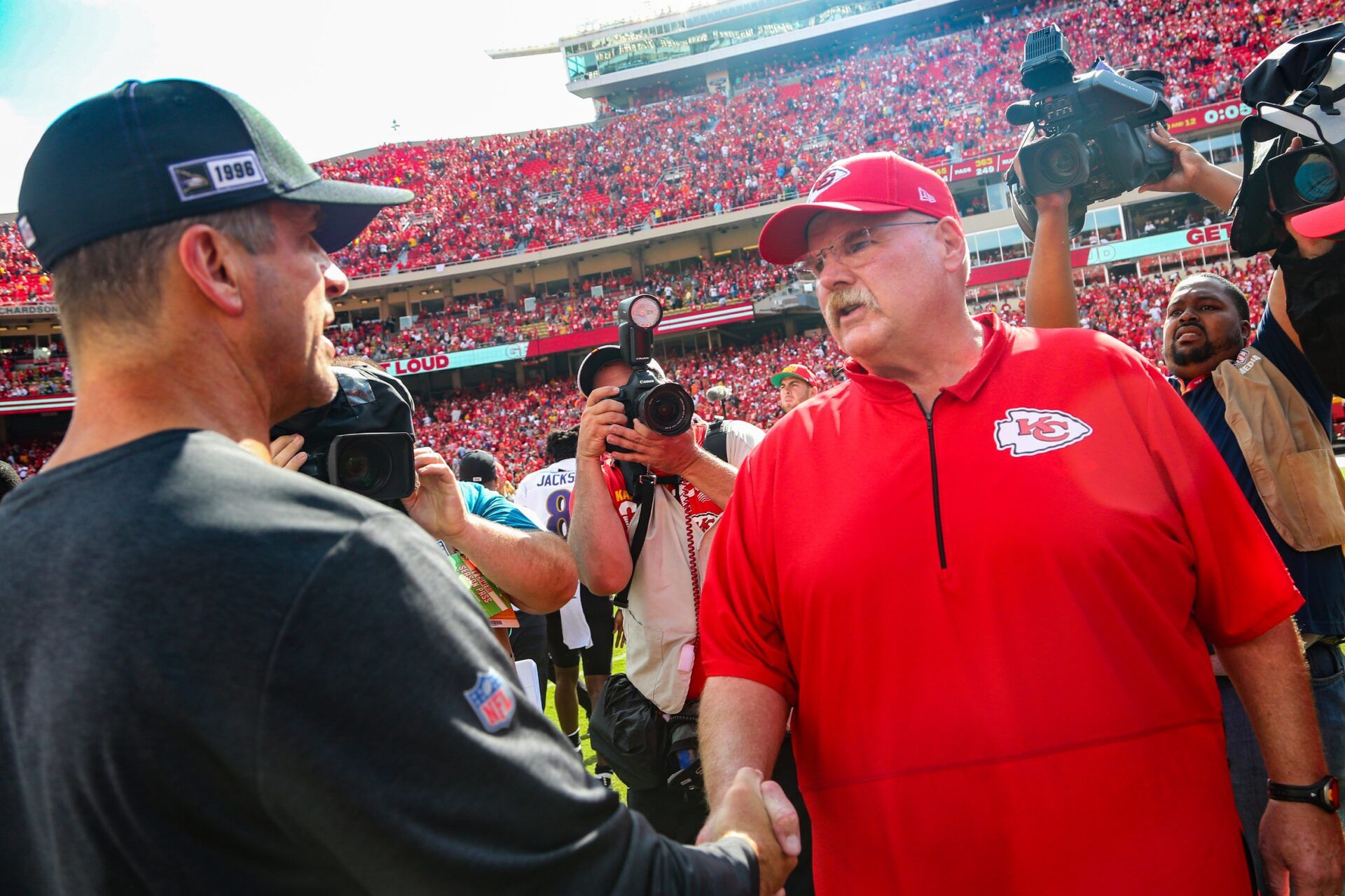 Kansas City Chiefs head coach Andy Reid talks with Baltimore Ravens head coach John Harbaugh after the game at Arrowhead Stadium.