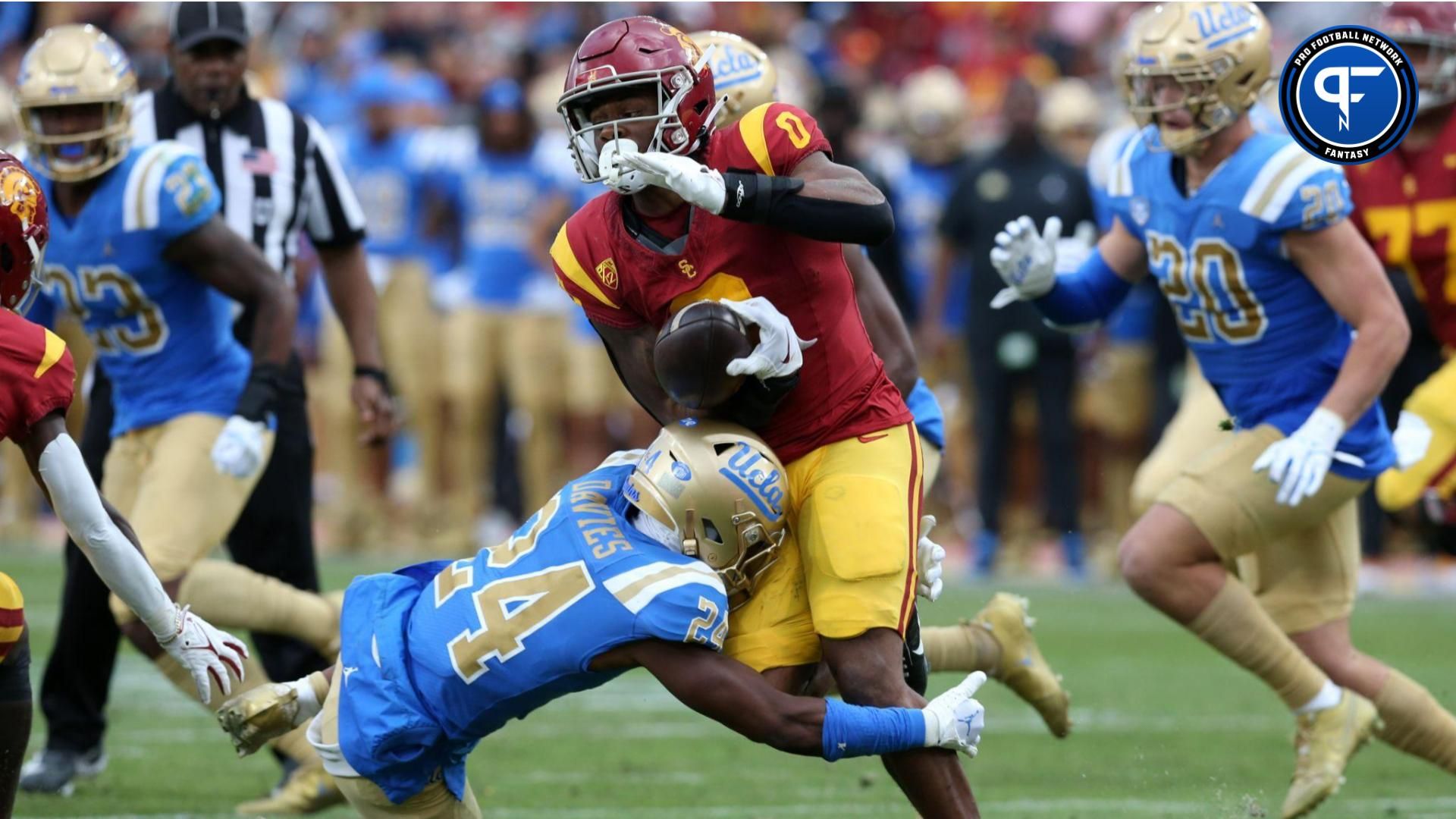 USC Trojans running back MarShawn Lloyd (0) fumbles after a hit by UCLA Bruins defensive back Jaylin Davies (24) during the third quarter at United Airlines Field