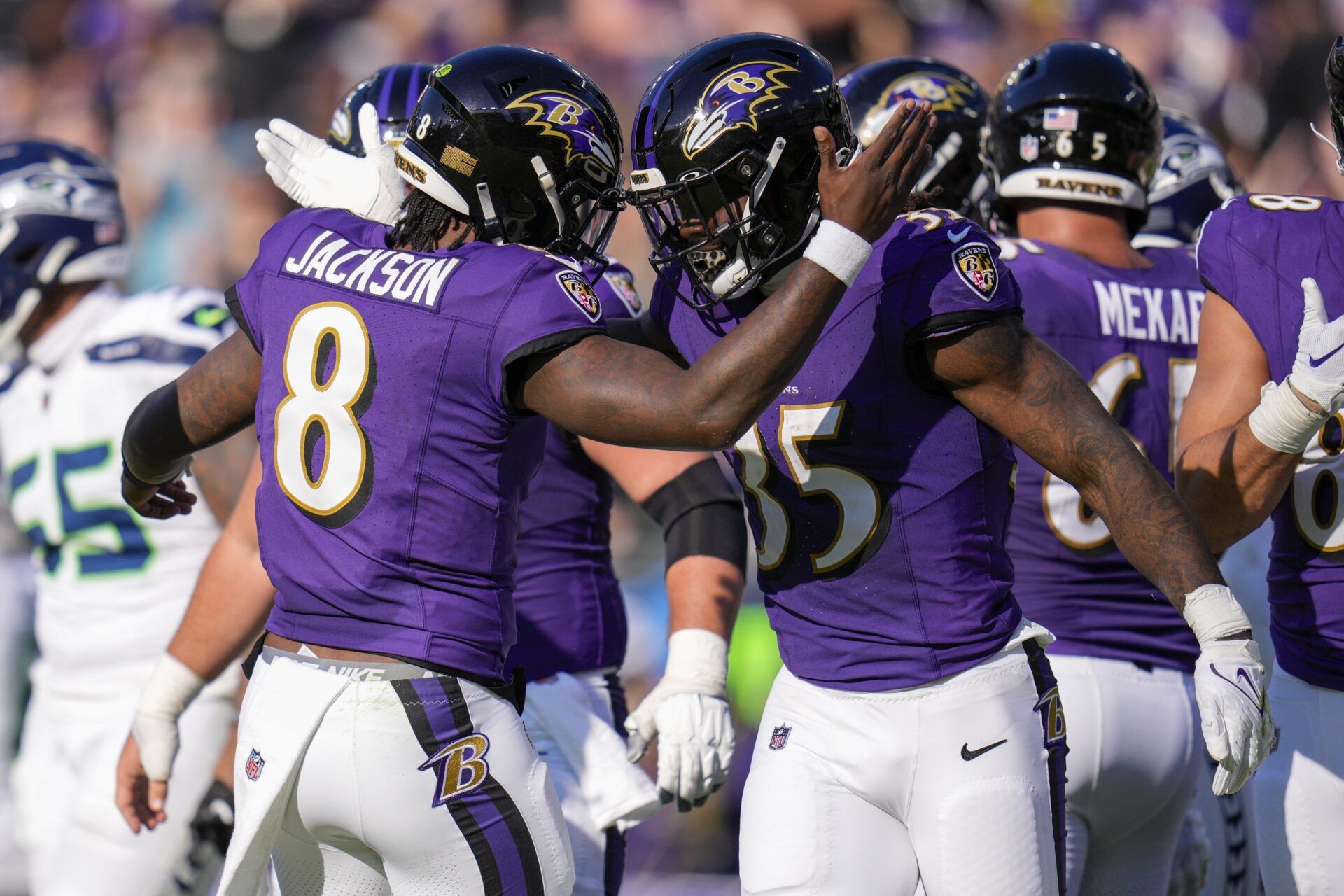 Baltimore Ravens quarterback Lamar Jackson (8) celebrates with running back Gus Edwards (35) after scoring a touchdown against the Seattle Seahawks during the second quarter at M&T Bank Stadium.