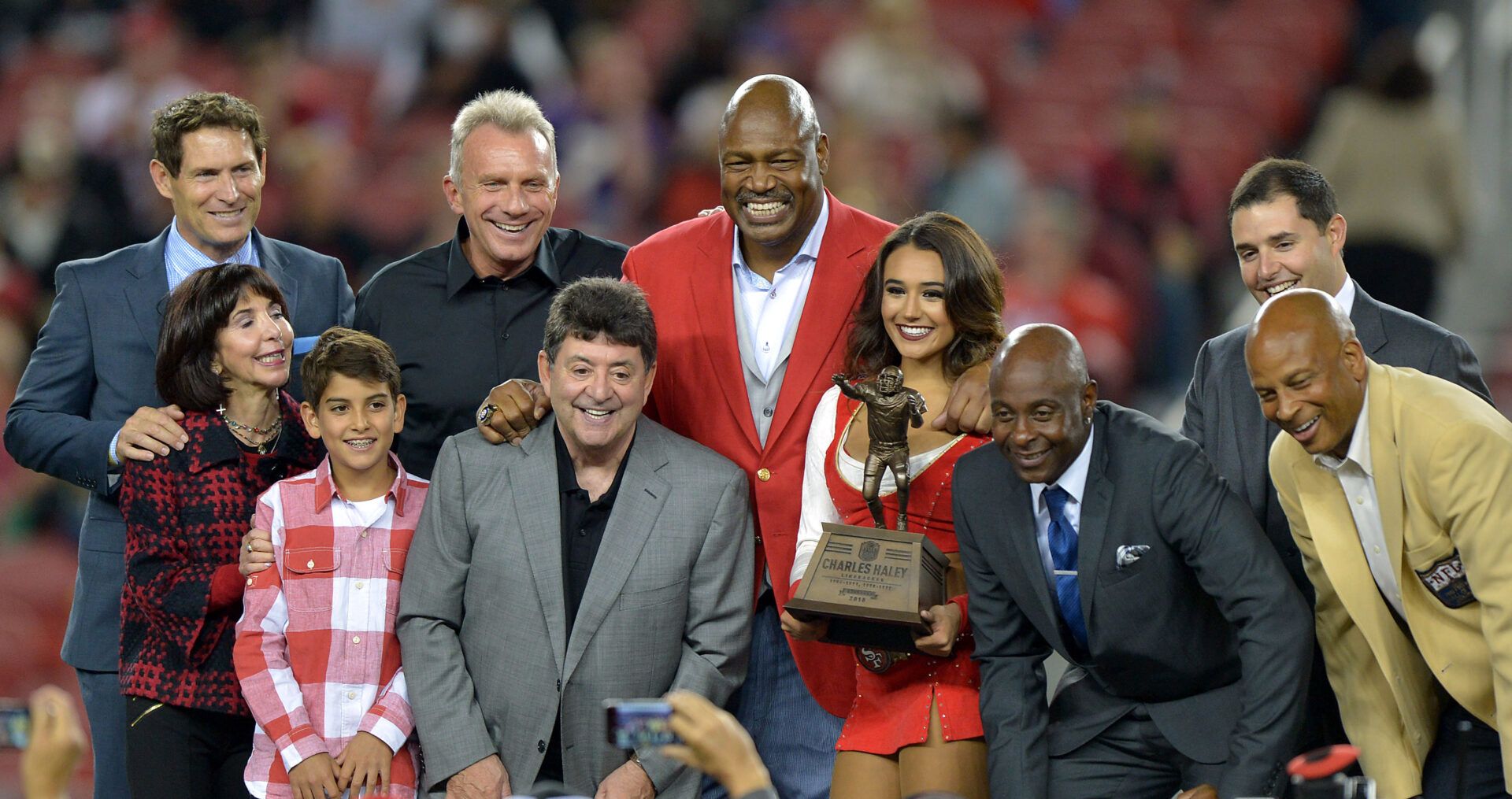 San Francisco 49ers former defensive end Charles Haley (center) poses with Steve Young, Denise DeBartolo York, Eddie DeBartolo Jr., Joe Montana, Jerry Rice, Jed York and Ronnie Lott during halftime ceremony at Levi's Stadium.