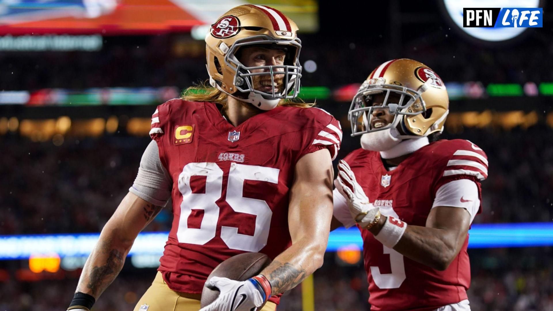 San Francisco 49ers tight end George Kittle (85) celebrates with wide receiver Ray-Ray McCloud III (3) after scoring a touchdown against the Green Bay Packers during the second quarter in a 2024 NFC divisional round game at Levi's Stadium.