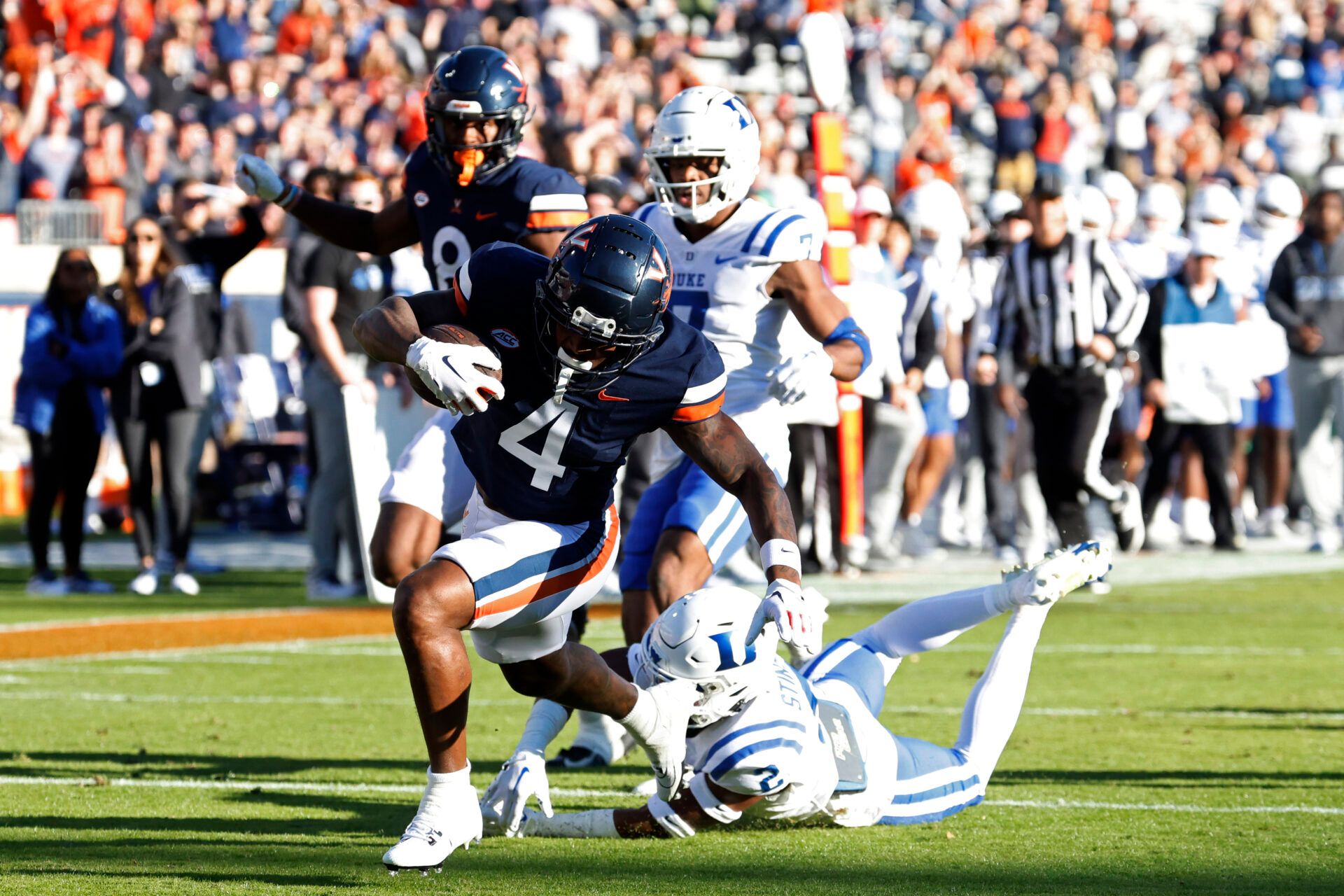 Virginia Cavaliers wide receiver Malik Washington (4) scores a touchdown as Duke Blue Devils safety Jaylen Stinson (2) chases during the first quarter at Scott Stadium.