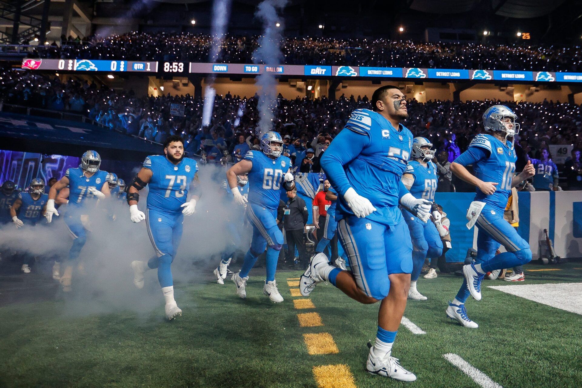 Detroit Lions offensive tackle Penei Sewell and quarterback Jared Goff lead the offensive players out of the tunnel as the team takes the field vs. the Tampa Bay Buccaneers in the NFC divisional round playoff game at Ford Field