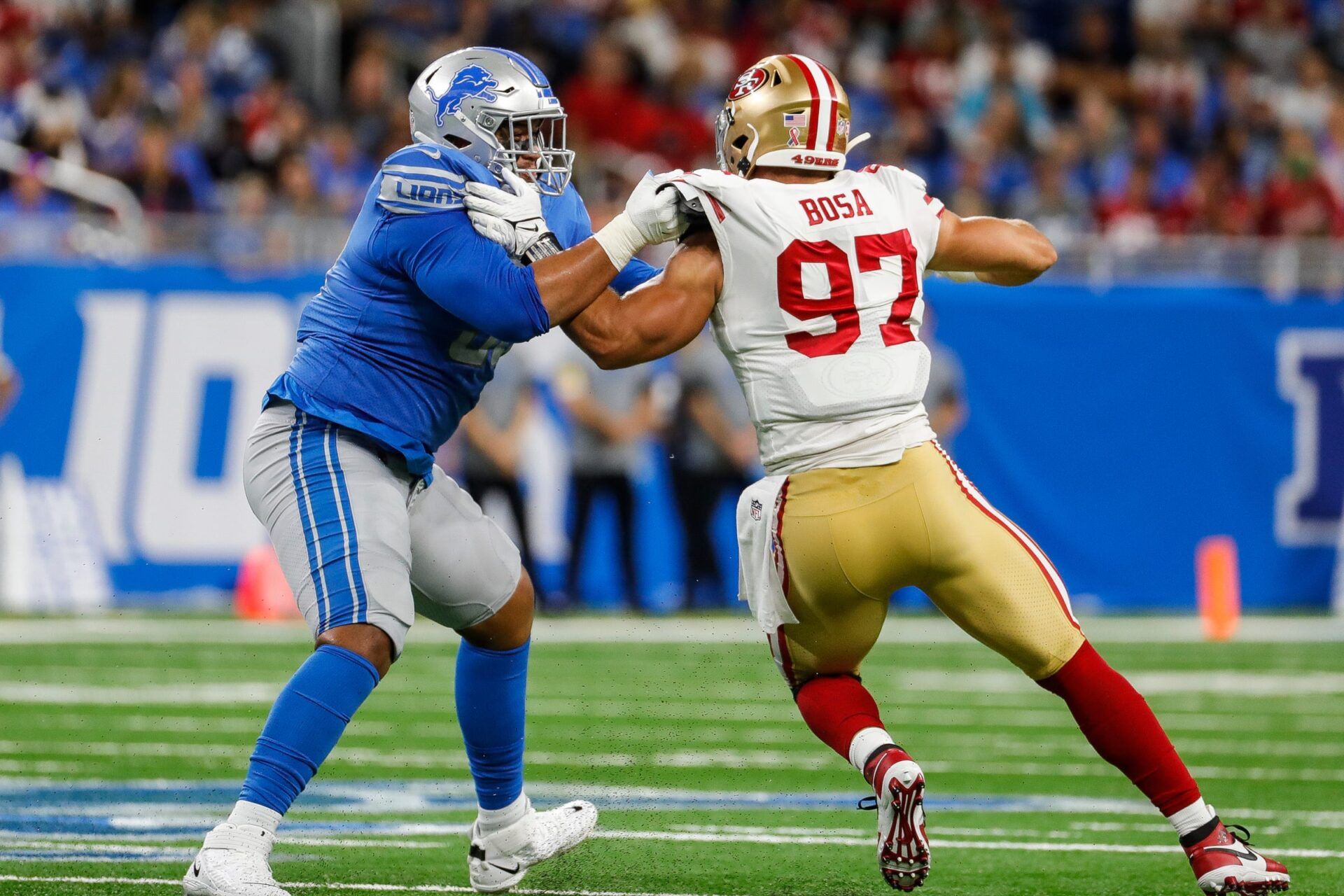 Detroit Lions offensive tackle Penei Sewell tries to stop San Francisco 49ers defensive end Nick Bosa during the first half at Ford Field