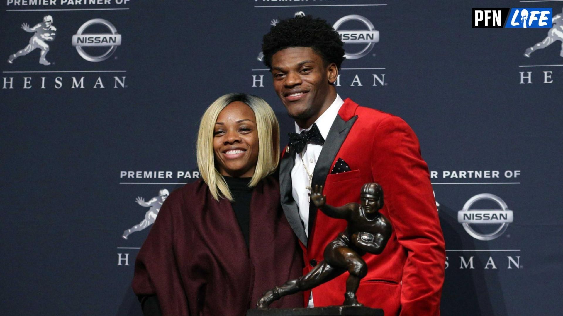 Louisville quarterback Lamar Jackson and his mother Felicia Jones pose with the trophy during a press conference at the New York Marriott Marquis after winning the 2016 Heisman Trophy award during a presentation at the Playstation Theater.