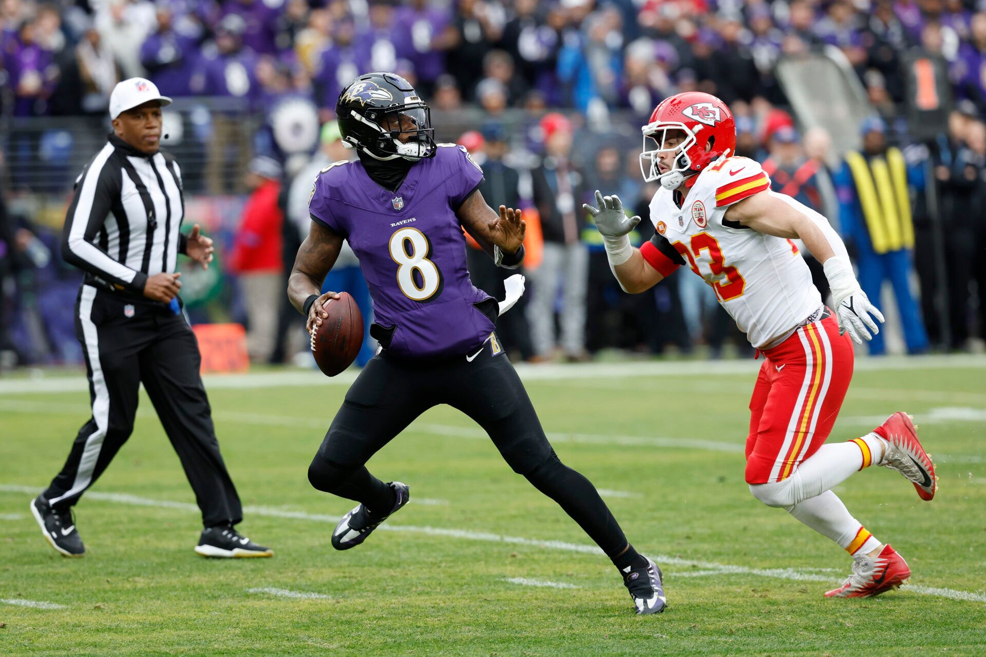 Baltimore Ravens quarterback Lamar Jackson (8) prepares to throw the ball as Kansas City Chiefs linebacker Drue Tranquill (23) defends during the first half in the AFC Championship football game at M&T Bank Stadium.