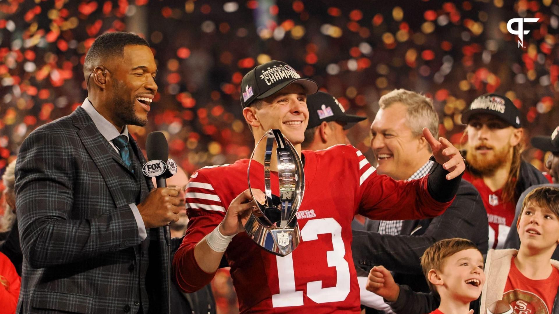 San Francisco 49ers quarterback Brock Purdy (13) holds the George Halas Trophy while after winning the NFC Championship football game against the Detroit Lions at Levi's Stadium.