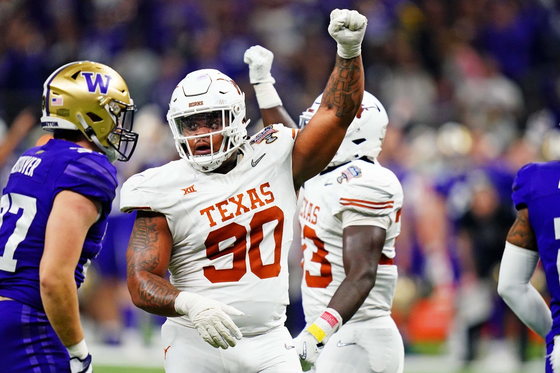 Texas Longhorns defensive lineman Byron Murphy II (90) celebrates after a play against Washington.