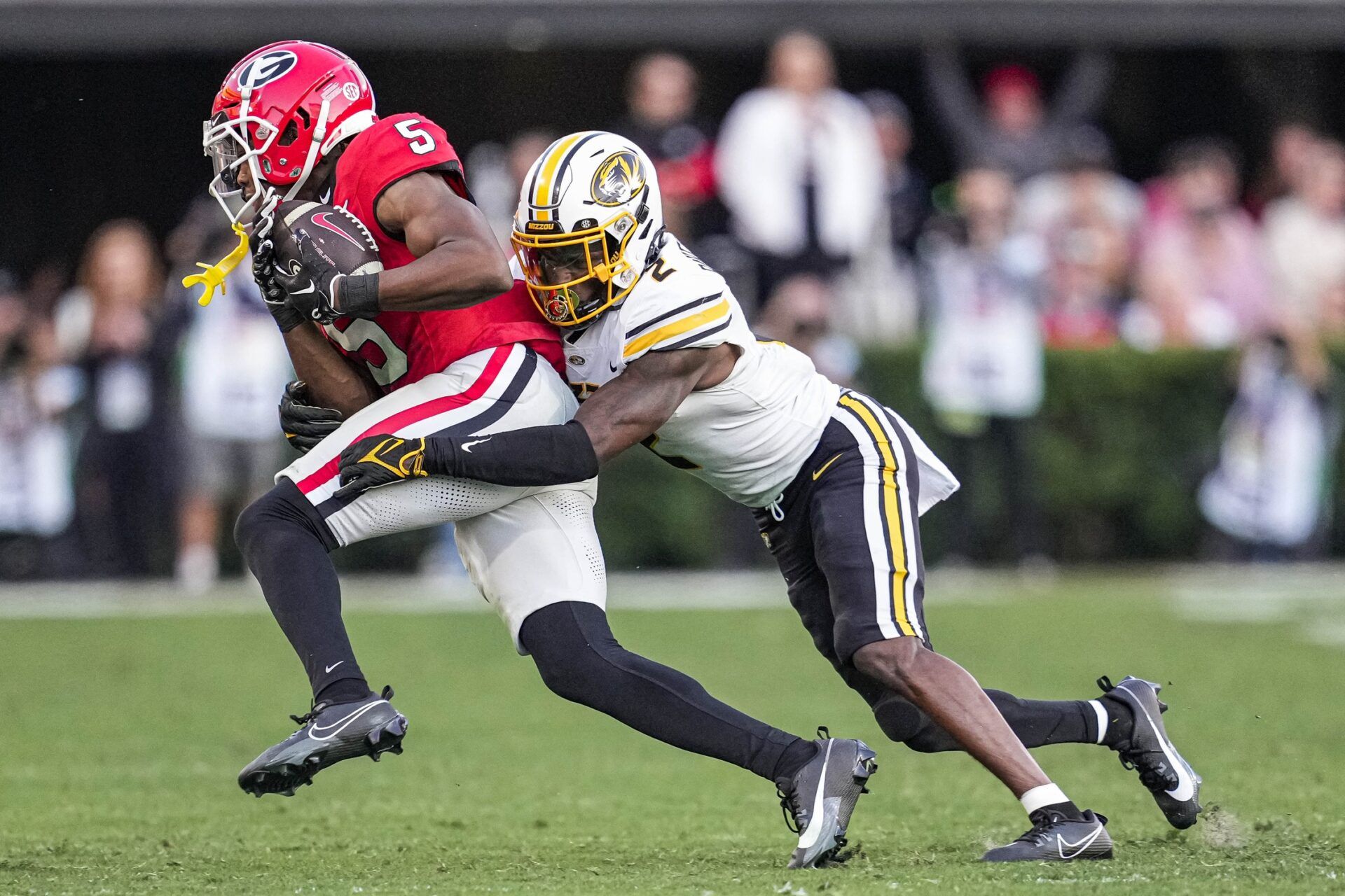 Georgia Bulldogs WR Rara Thomas (5) is tackled by Missouri Tigers DB Ennis Rakestraw Jr. (2).