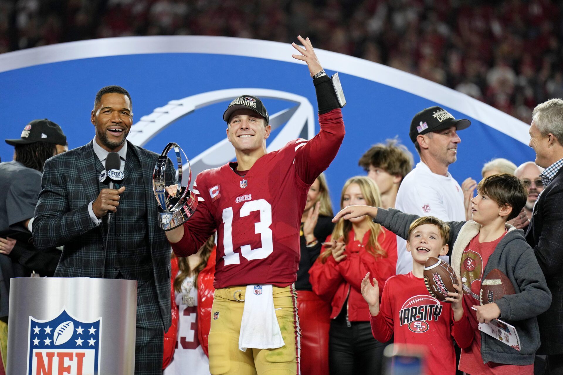 San Francisco 49ers quarterback Brock Purdy (13) celebrates with the George Halas Trophy after winning the NFC Championship football game against the Detroit Lions at Levi's Stadium.