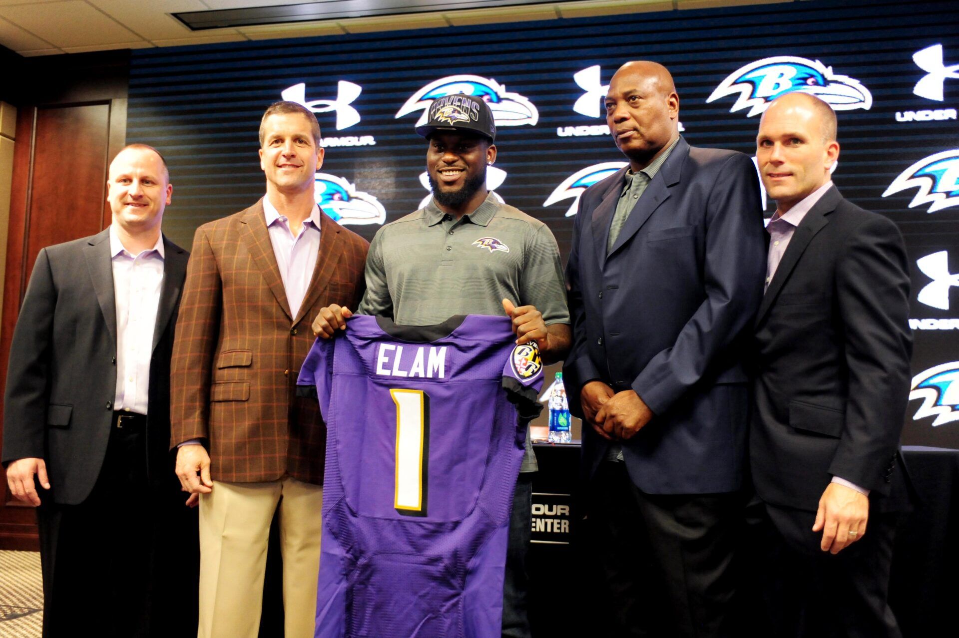 Baltimore Ravens safety Matt Elam (center) is introduced to the media with (from left to right) national scout Joe Hortiz, head coach John Harbaugh, general manager Ozzie Newsome, and director of college scouting Eric DeCosta at the Under Armour Performance Center.