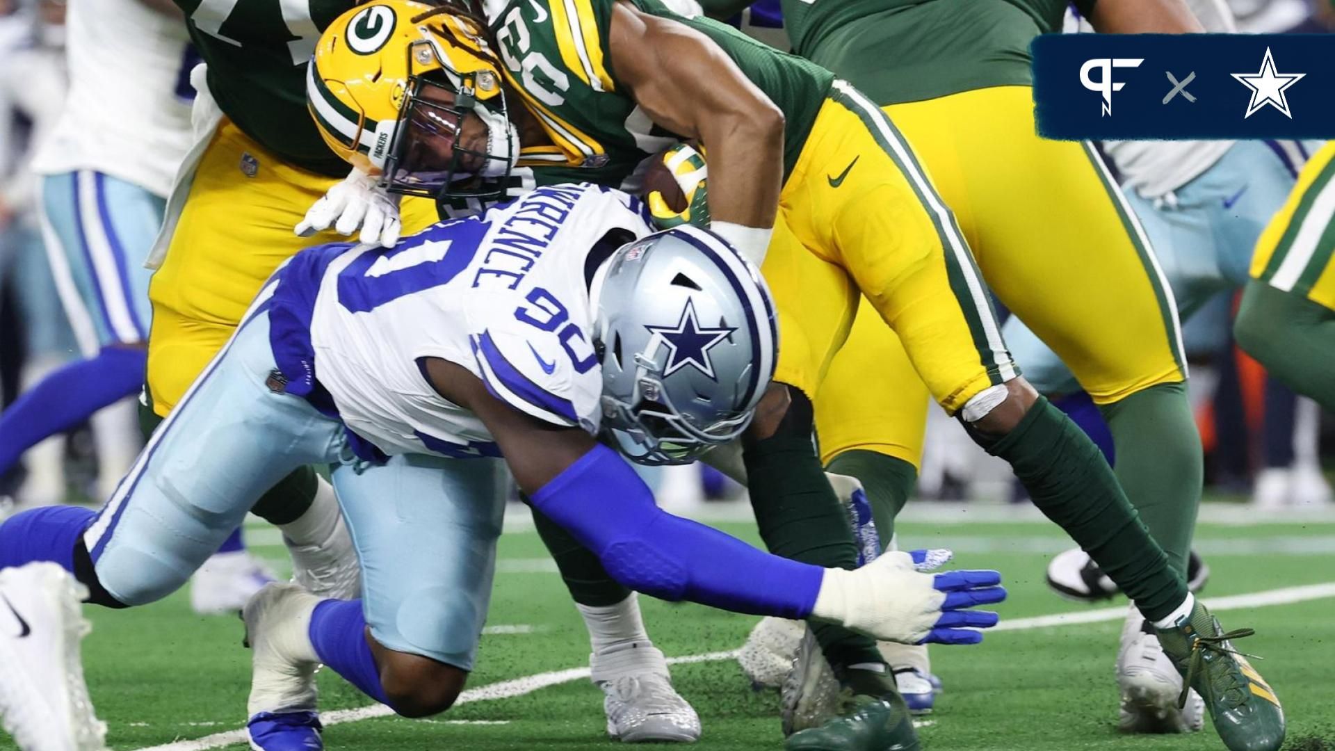 Dallas Cowboys DE DeMarcus Lawrence (90) tackles Green Bay Packers RB Aaron Jones (33).