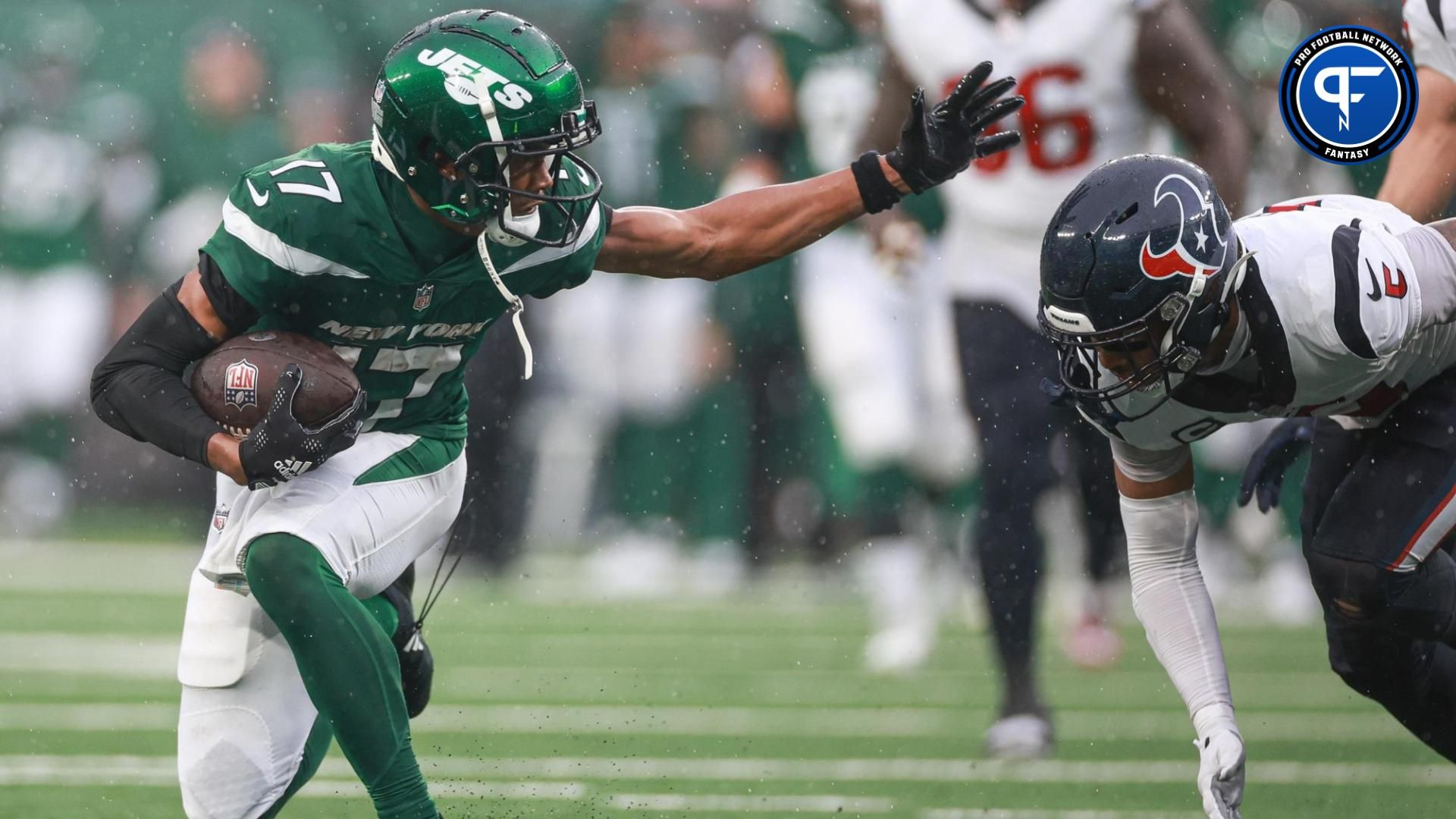 New York Jets wide receiver Garrett Wilson (17) fights for yards as Houston Texans safety Jalen Pitre (5) pursues during the second half at MetLife Stadium.