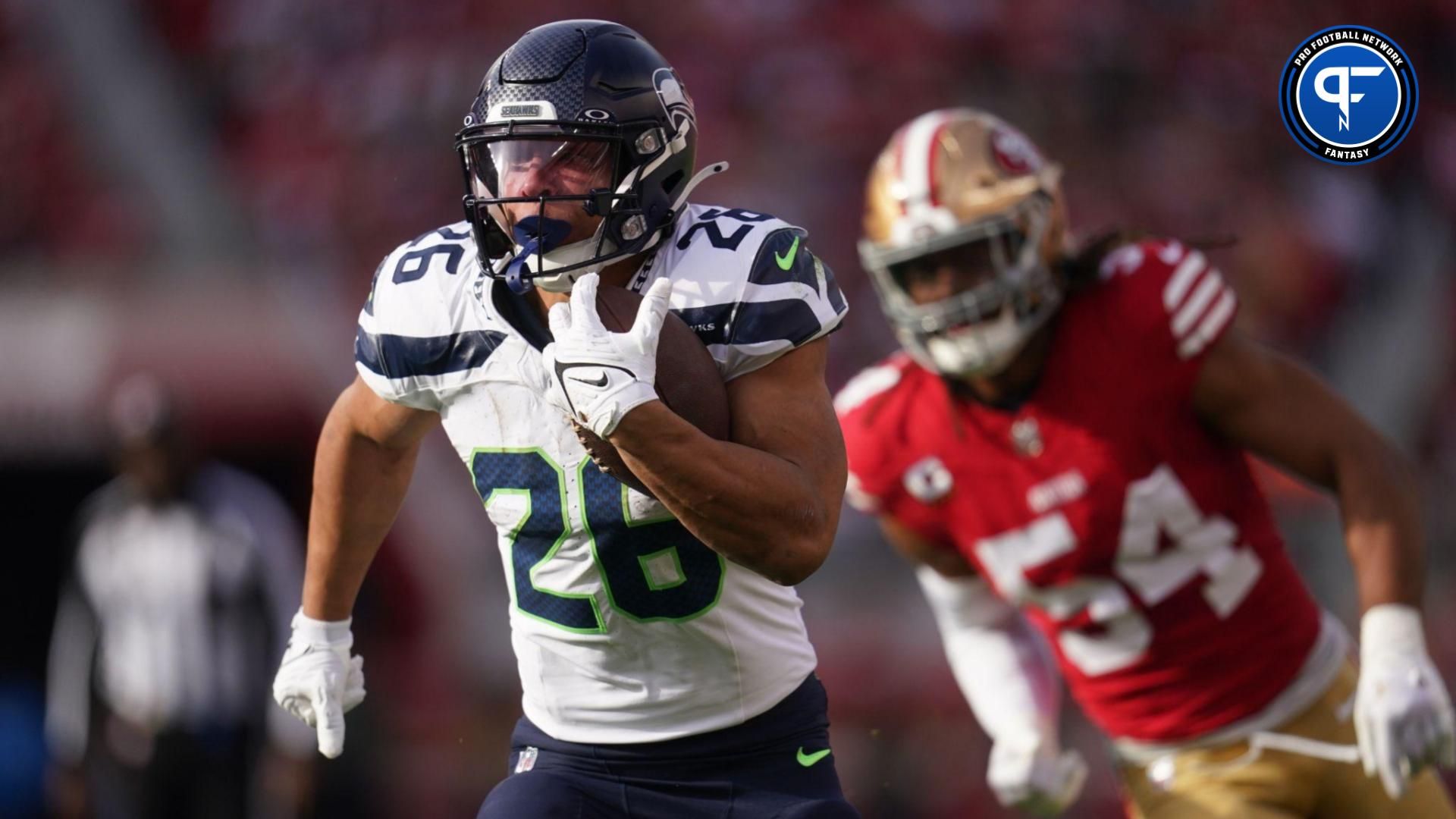 Seattle Seahawks running back Zach Charbonnet (26) runs past San Francisco 49ers linebacker Fred Warner (54) in the first quarter at Levi's Stadium.