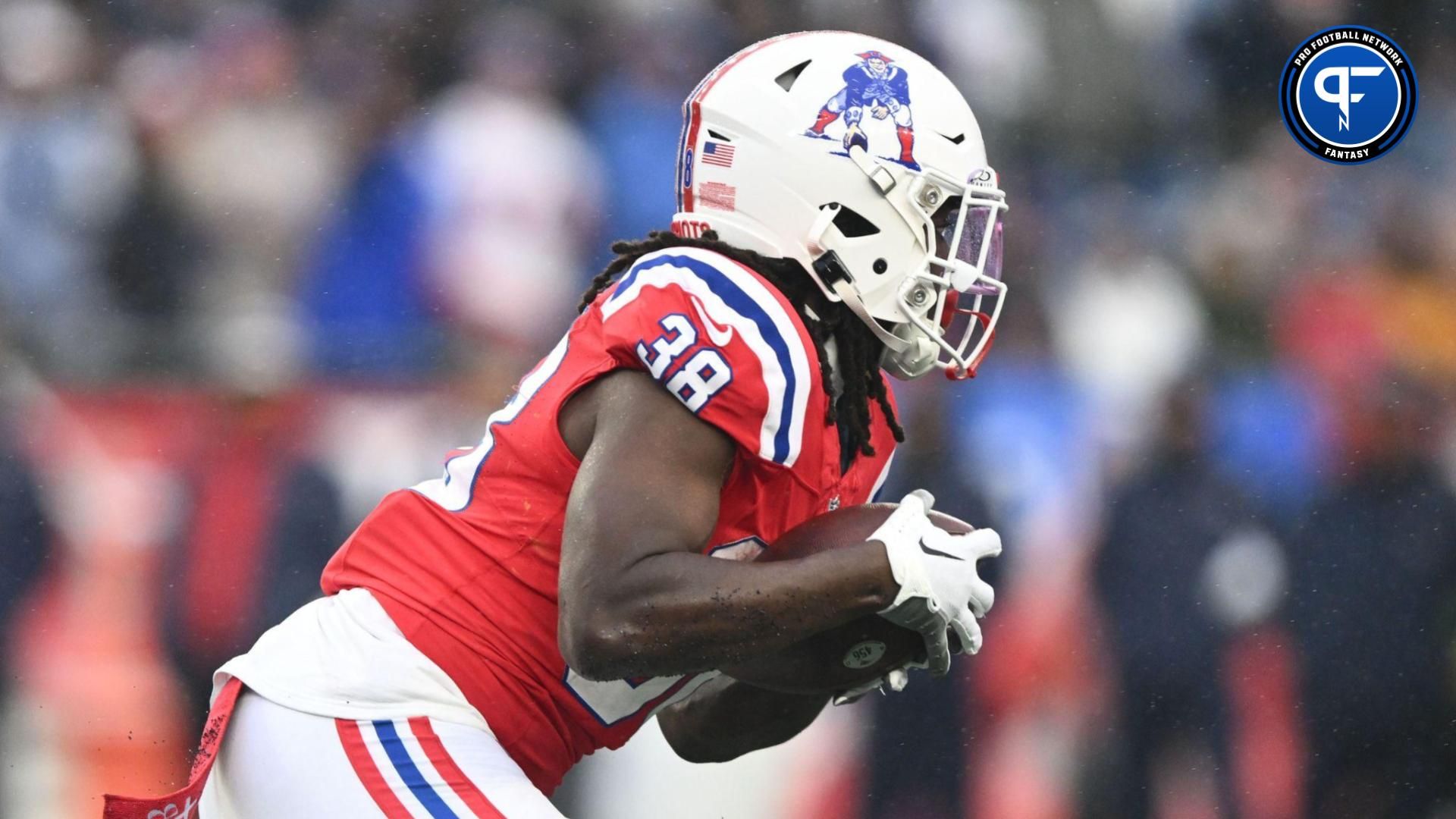 New England Patriots running back Rhamondre Stevenson (38) rushes against the Los Angeles Chargers during the first half at Gillette Stadium.