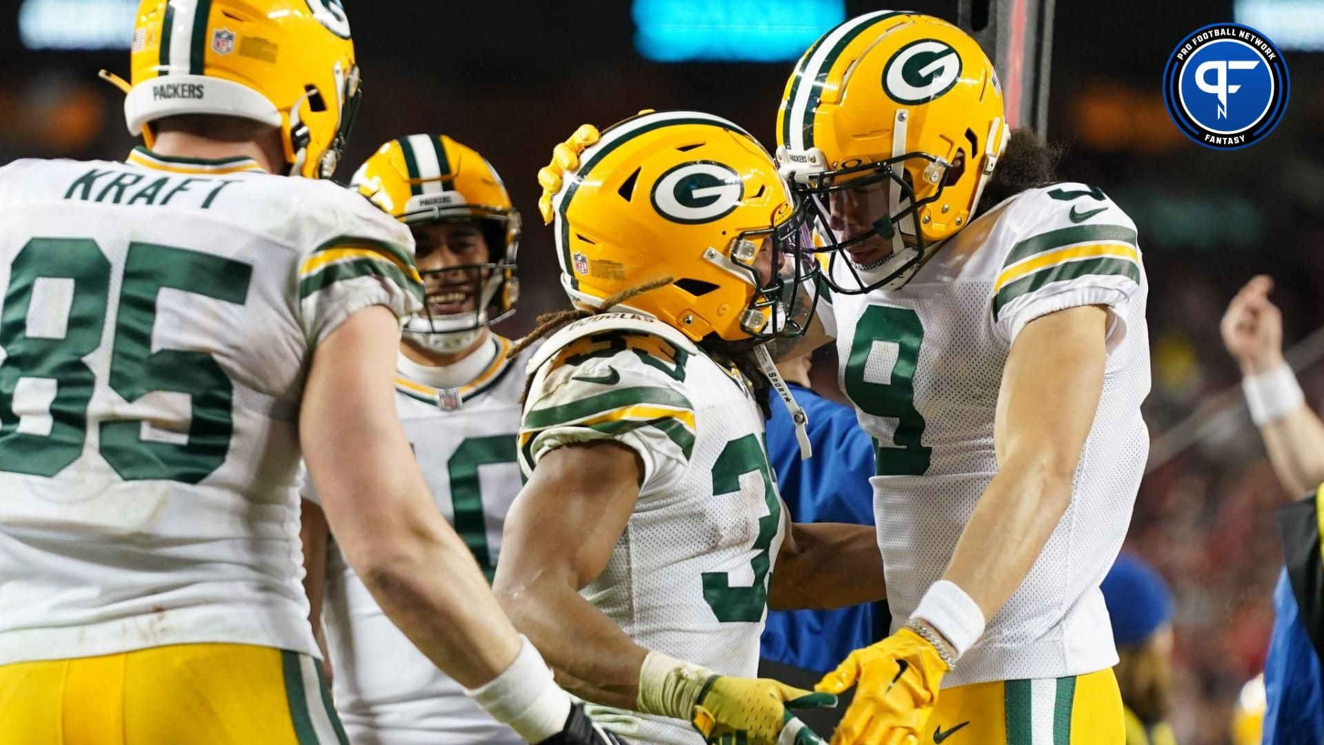 Green Bay Packers running back Aaron Jones (33) celebrates with wide receiver Christian Watson (9) and tight end Tucker Kraft (85) after a two point conversion against the San Francisco 49ers during the third quarter in a 2024 NFC divisional round game at Levi's Stadium.