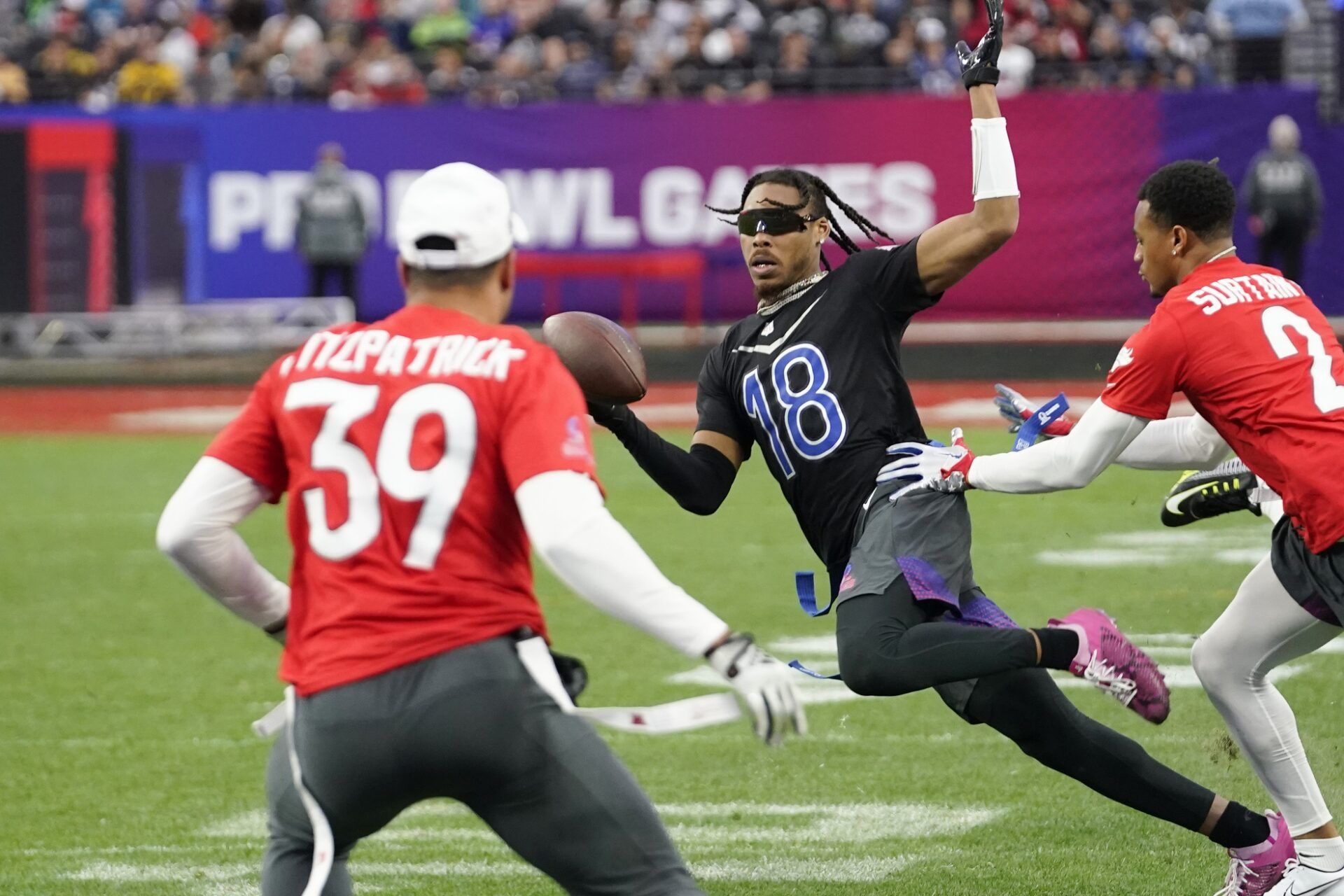 NFC wide receiver Justin Jefferson of the Minnesota Vikings (18) runs the ball against AFC cornerback Pat Surtain II of the Denver Broncos (2) and right safety Jamal Agnew of the Jacksonville Jaguars (39) during game three of the 2023 Pro Bowl at Allegiant Stadium.