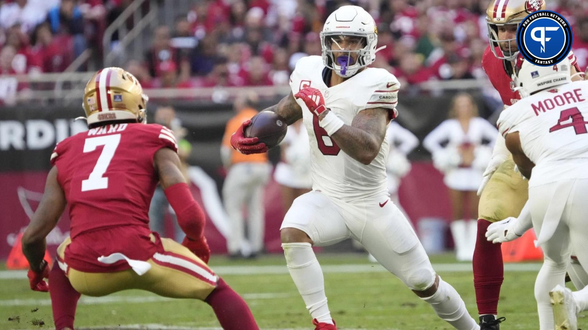 Arizona Cardinals running back James Conner (6) looks to get around San Francisco 49ers cornerback Charvarius Ward (7) during the second quarter at State Farm Stadium in Glendale on Dec. 17, 2023.