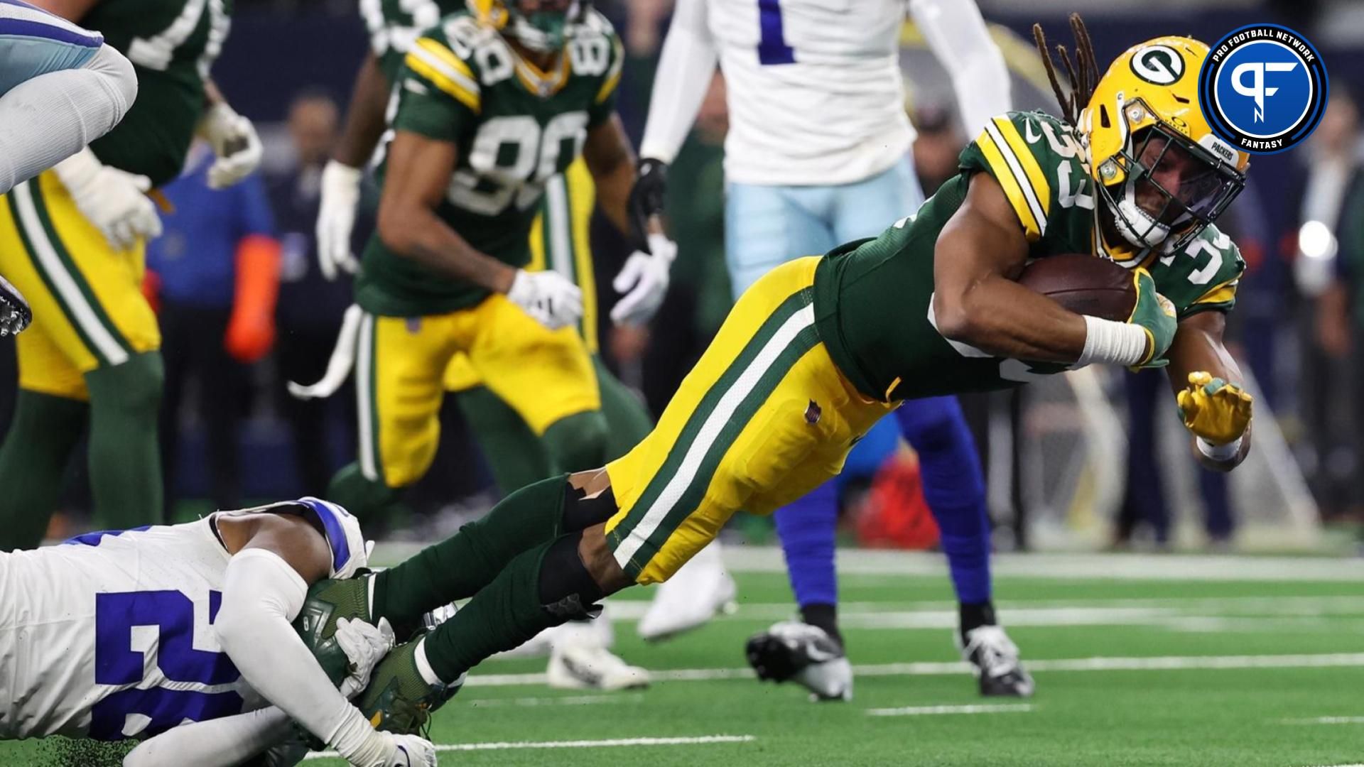 Green Bay Packers running back Aaron Jones (33) rushes the ball for a touchdown against the Dallas Cowboys in the second half for the 2024 NFC wild card game at AT&T Stadium.