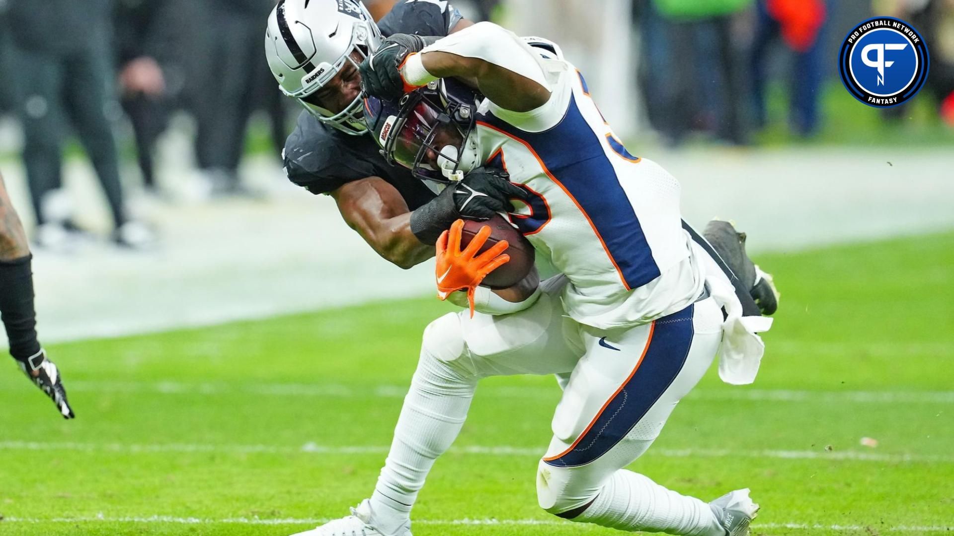 Denver Broncos running back Javonte Williams (33) is tackled by Las Vegas Raiders linebacker Divine Deablo (5) during the second quarter at Allegiant Stadium.