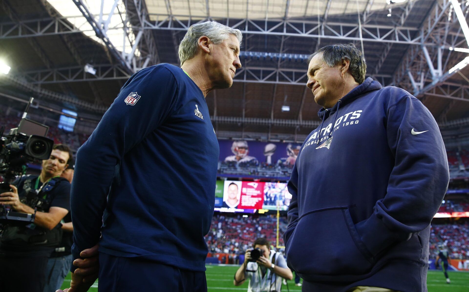 Seattle Seahawks head coach Pete Carroll (left) greets New England Patriots head coach Bill Belichick (right) before Super Bowl XLIX at University of Phoenix Stadium