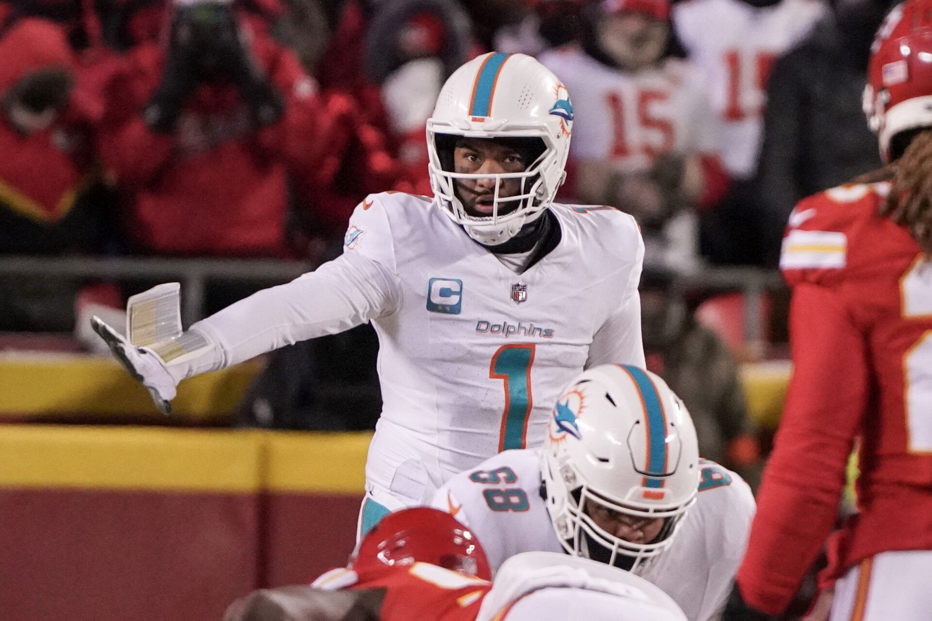 Miami Dolphins quarterback Tua Tagovailoa (1) gestures at the line of scrimmage against the Kansas City Chiefs in a 2024 AFC wild card game at GEHA Field at Arrowhead Stadium.