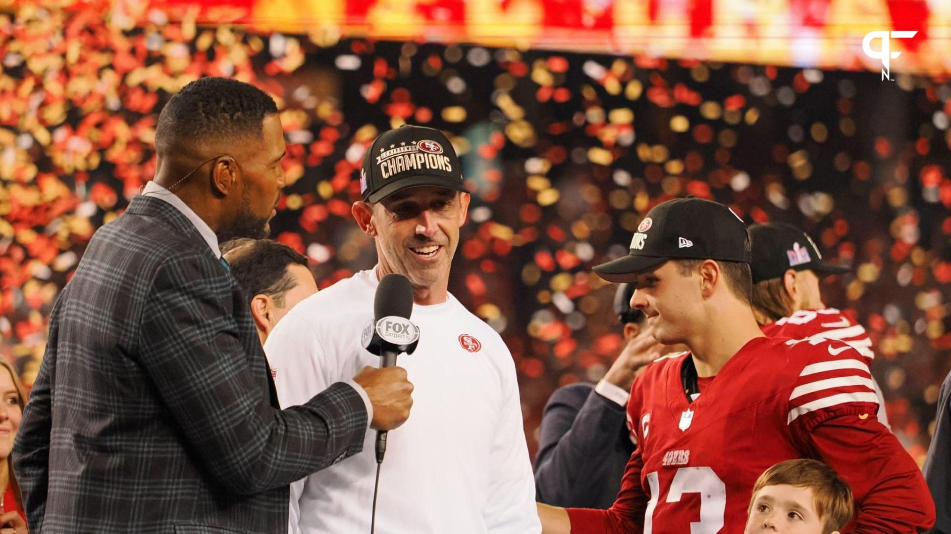 Fox Sports broadcaster and former NFL player Michael Strahan interviews San Francisco 49ers head coach Kyle Shanahan after winning the NFC Championship football game against the Detroit Lions at Levi'...