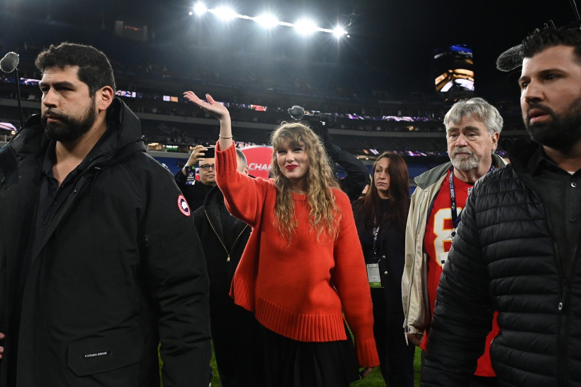 American singer-songwriter Taylor Swift (center) walks off the field after the Kansas City Chiefs won the AFC Championship Game against the Baltimore Ravens.