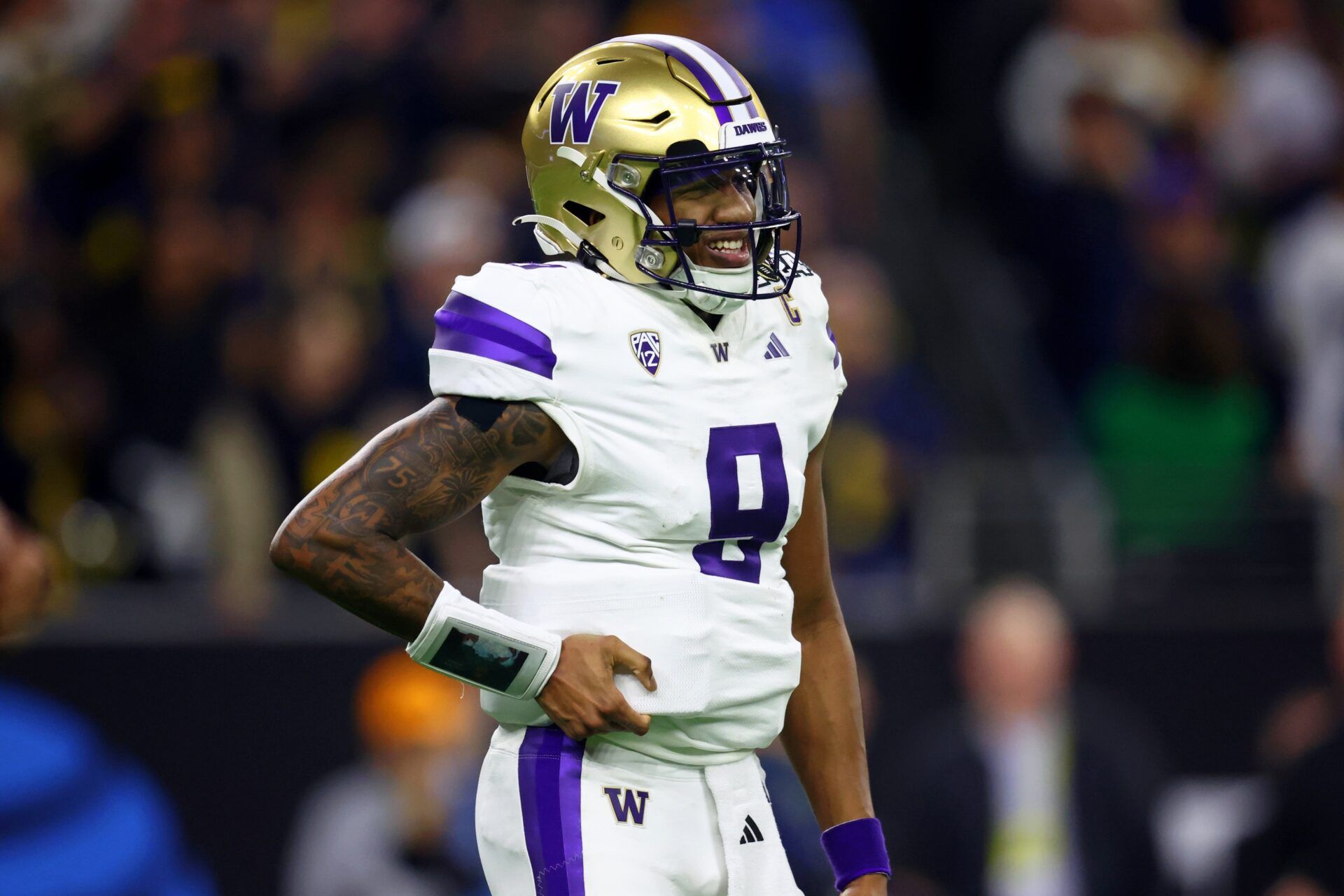 Washington Huskies quarterback Michael Penix Jr. (9) reacts after a play against the Michigan Wolverines in the CFP National Championship.