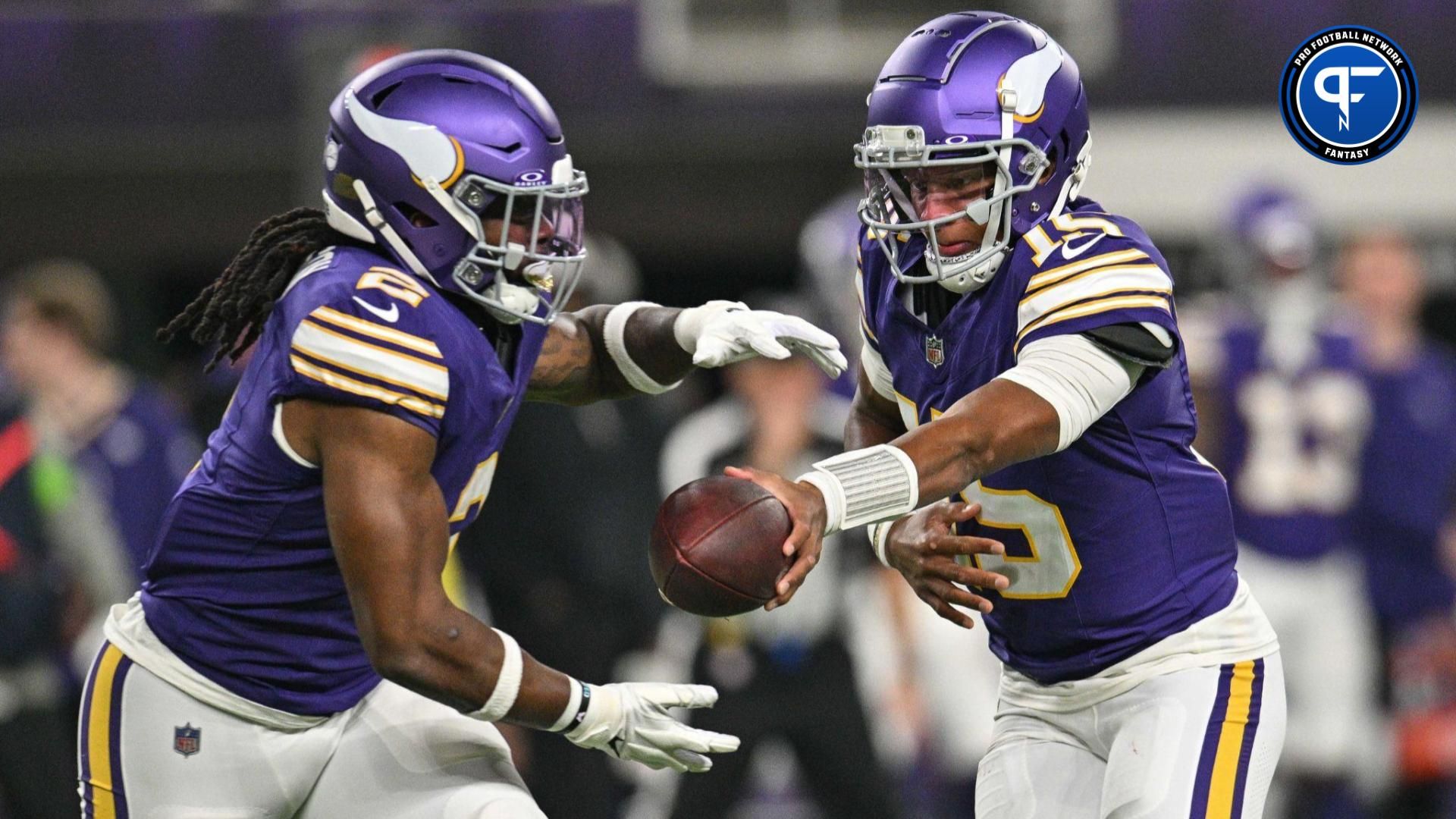 Minnesota Vikings quarterback Joshua Dobbs (15) hands the ball off to running back Alexander Mattison (2) during the game against the Chicago Bears at U.S. Bank Stadium.