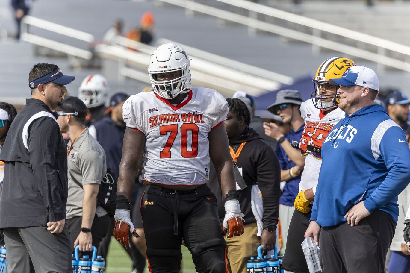 American offensive lineman Christian Jones of Texas (70) talks with coaches between plays during practice for the American team at Hancock Whitney Stadium.