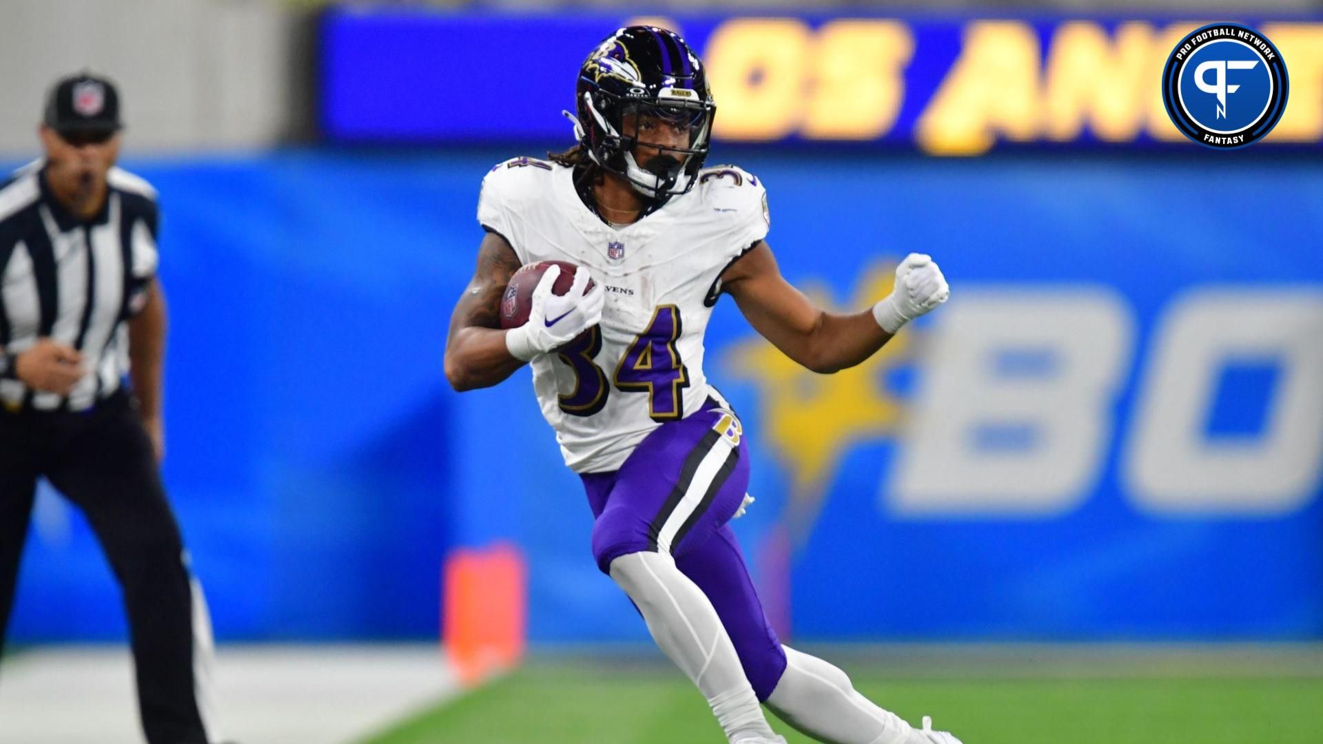 Baltimore Ravens running back Keaton Mitchell (34) runs the ball against the Los Angeles Chargers during the first half at SoFi Stadium.