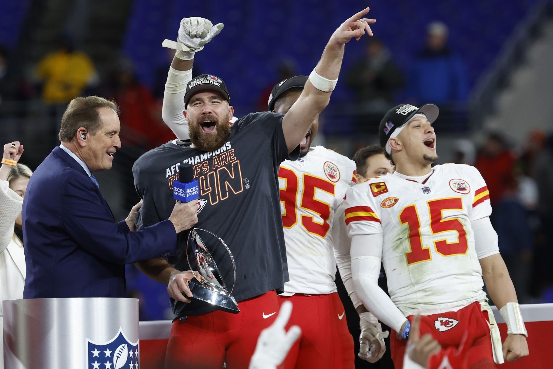 Kansas City Chiefs tight end Travis Kelce (M) celebrates with the Lamar Hunt Trophy while speaking with CBS broadcaster Jim Nance during the trophy presentation after the Chiefs' game against the Baltimore Ravens in the AFC Championship football game at M&T Bank Stadium.