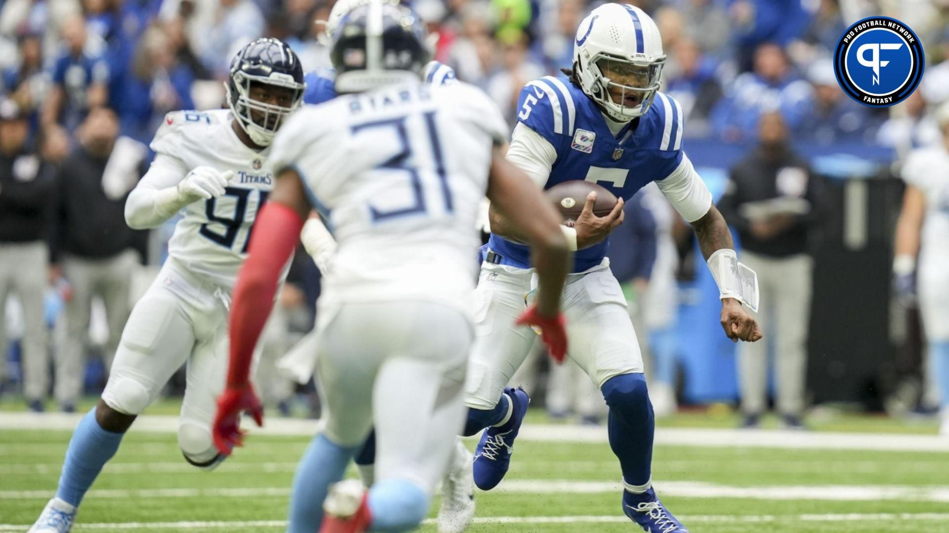 Indianapolis Colts quarterback Anthony Richardson (5) looks to run with the ball during a game against the Tennessee Titans Lucas Oil Stadium.