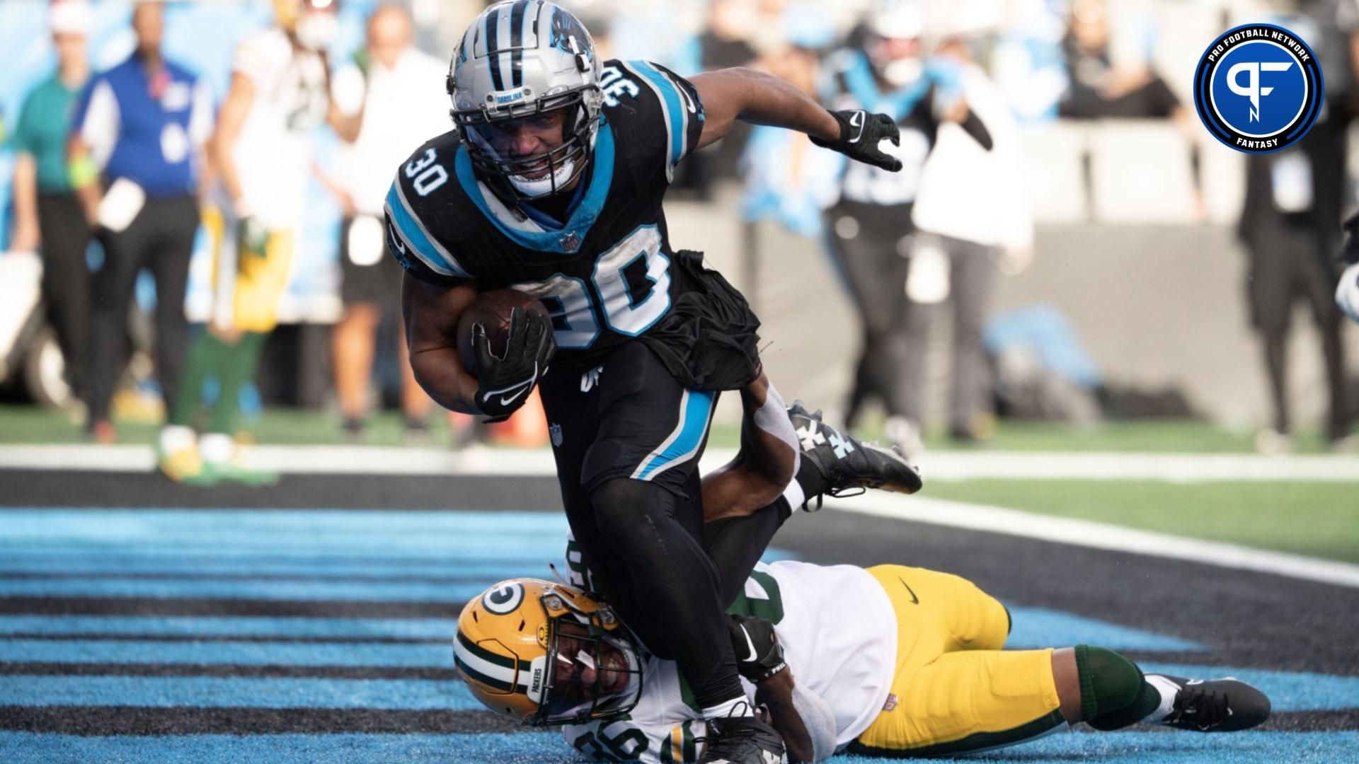 Carolina Panthers running back Chuba Hubbard (30) scores a touchdown as Green Bay Packers safety Darnell Savage (26) defends in the third quarter at Bank of America Stadium.