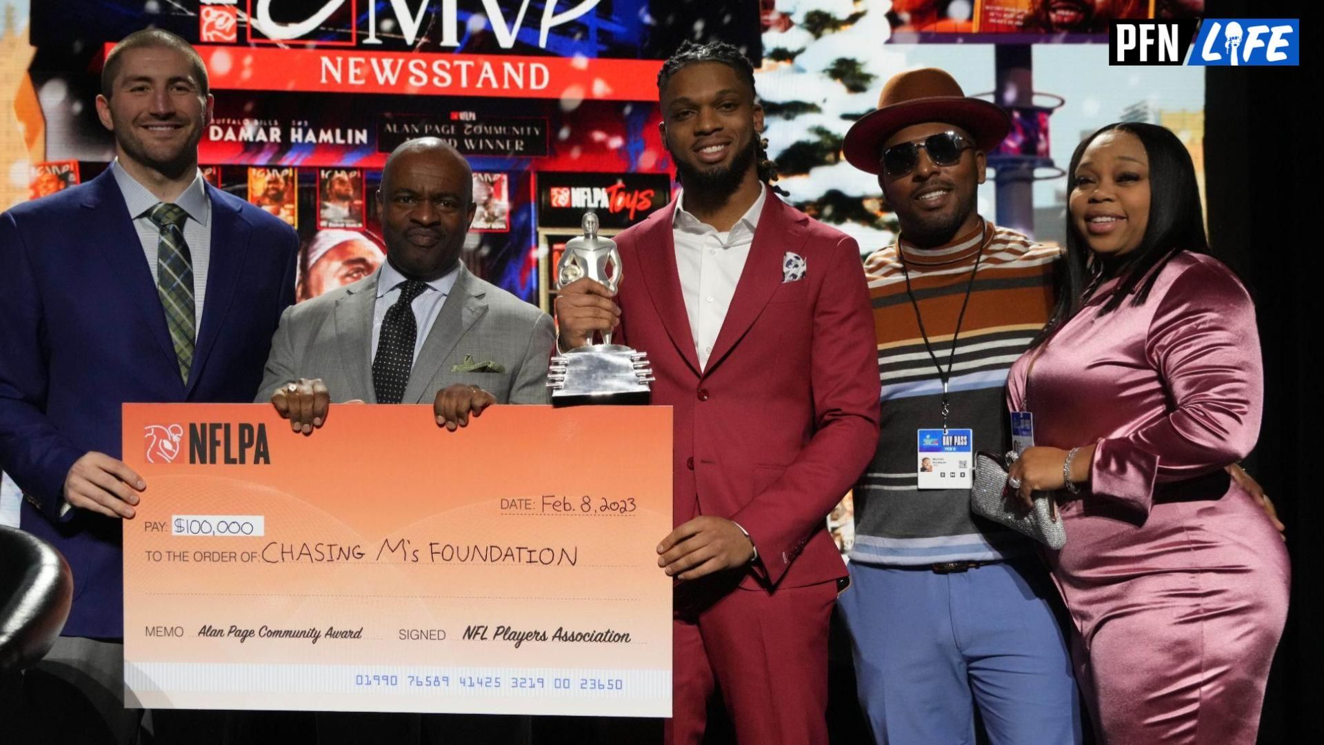 Buffalo Bills safety Damar Hamlin (center) poses with NFLPA president JC Tretter and executive director DeMaurice Smith, father Mario Hamlin and mother Nina Hamlin after receiving the Alan Page Community Award during the NFLPA press conference at the Phoenix Convention Center.