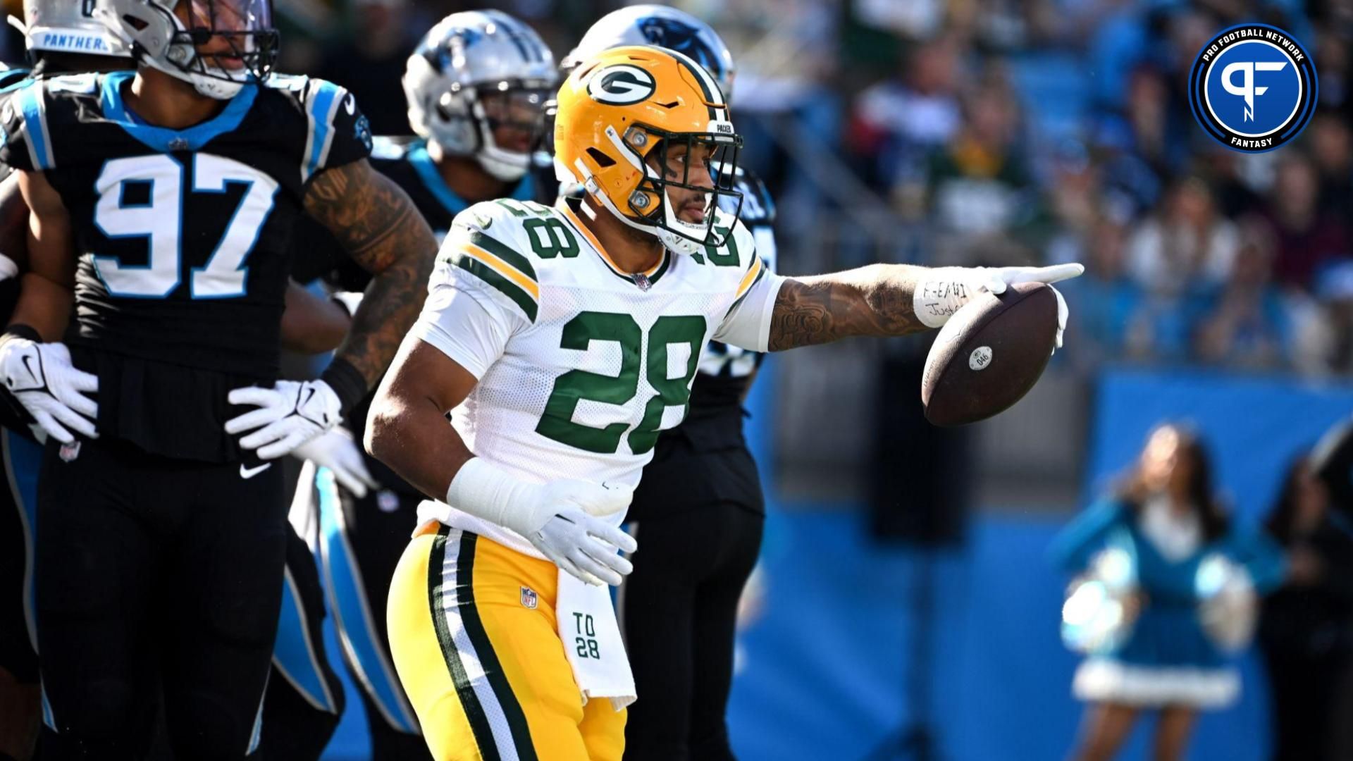 Green Bay Packers running back AJ Dillon (28) reacts after scoring a touchdown in the first quarter at Bank of America Stadium.