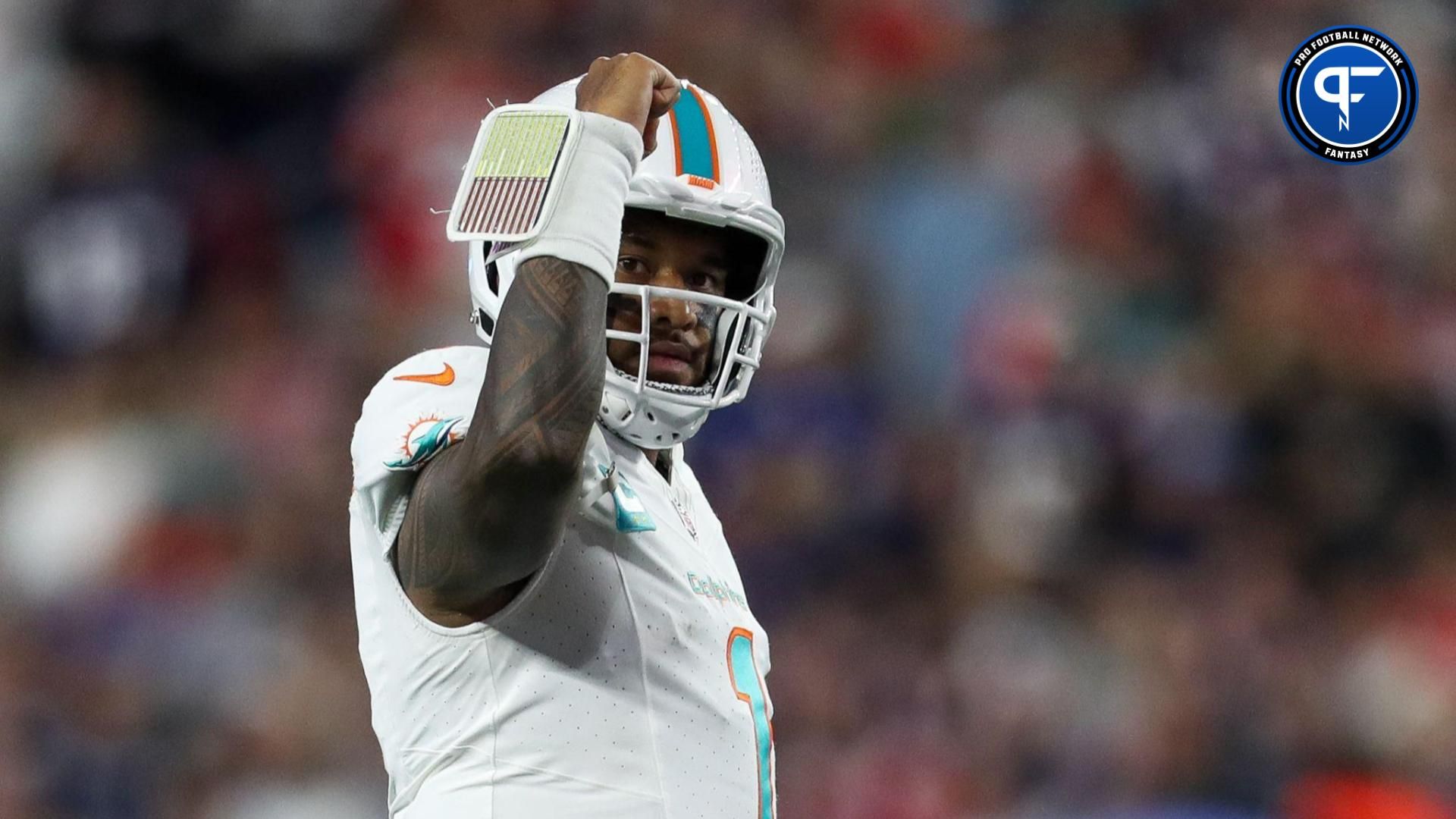 Miami Dolphins quarterback Tua Tagovailoa (1) celebrates after a touchdown during the first half against the New England Patriots at Gillette Stadium.