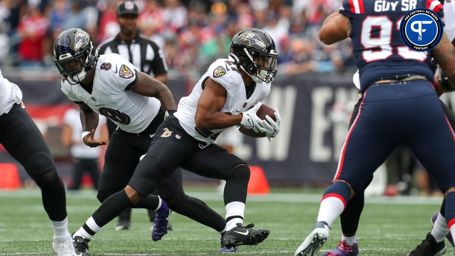 Baltimore Ravens running back JK Dobbins (27) runs the ball during the first half against the New England Patriots at Gillette Stadium.