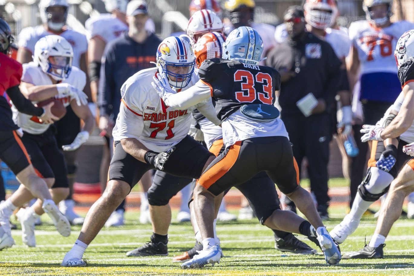 National offensive lineman Dominick Puni of Kansas (71) blocks against National linebacker Cedric Gray of North Carolina (33) during practice for the National team at Hancock Whitney Stadium.