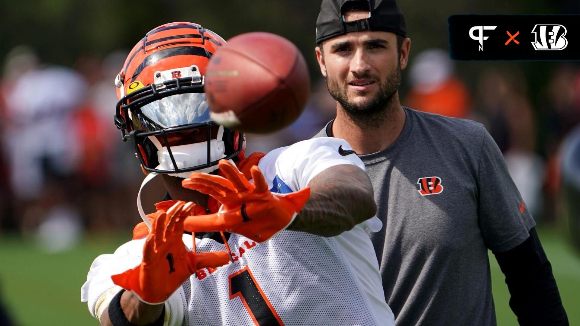 Cincinnati Bengals wide receiver Ja'Marr Chase (1) catches passes from Jugs football passing machine as assistant wide receivers coach Brad Kragthorpe assists at the conclusion of Cincinnati Bengals t...