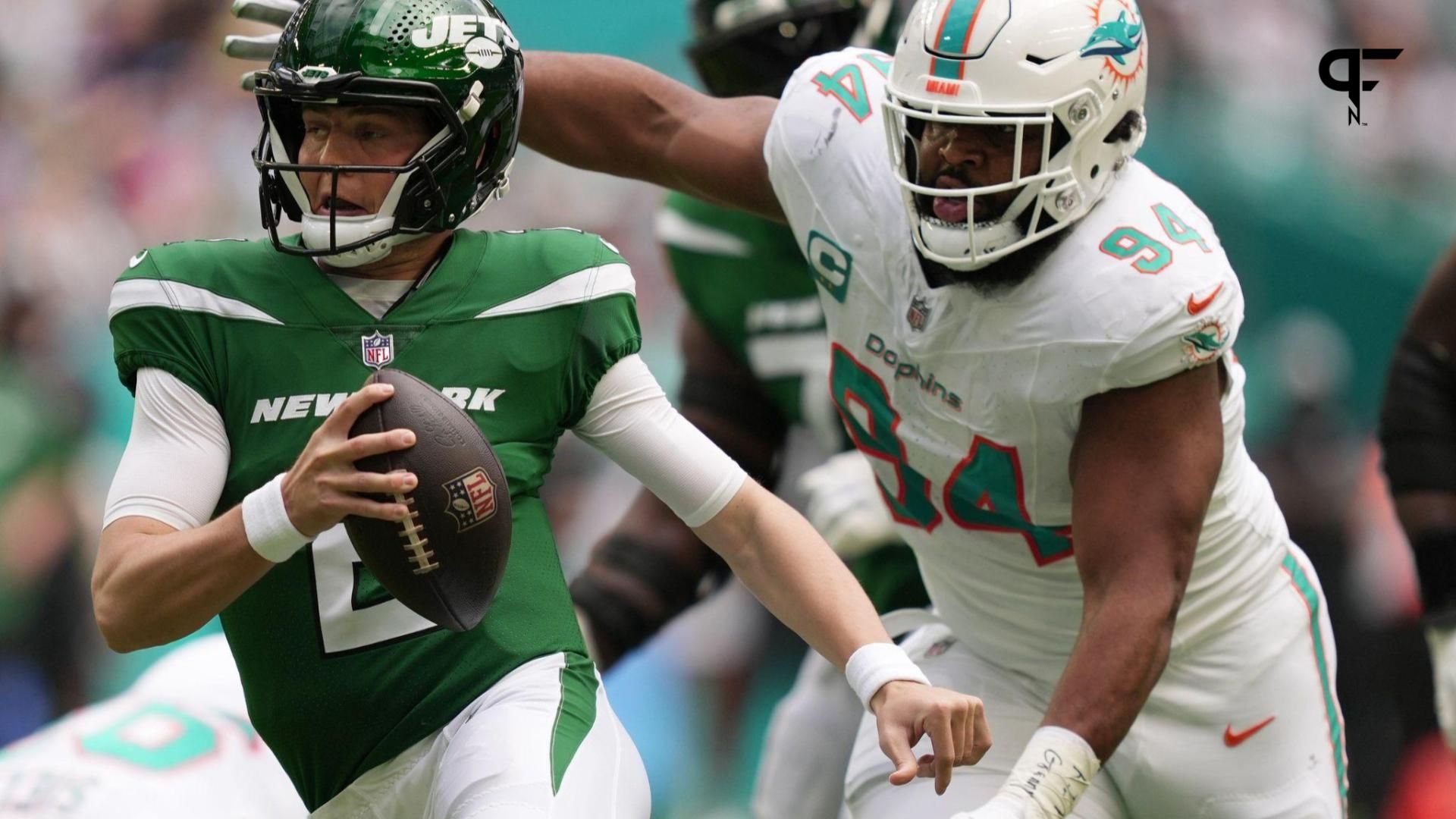 New York Jets quarterback Zach Wilson (2) tries to elude the pressure of Miami Dolphins defensive tackle Christian Wilkins (94) during the first half of an NFL game at Hard Rock Stadium in Miami Garde...